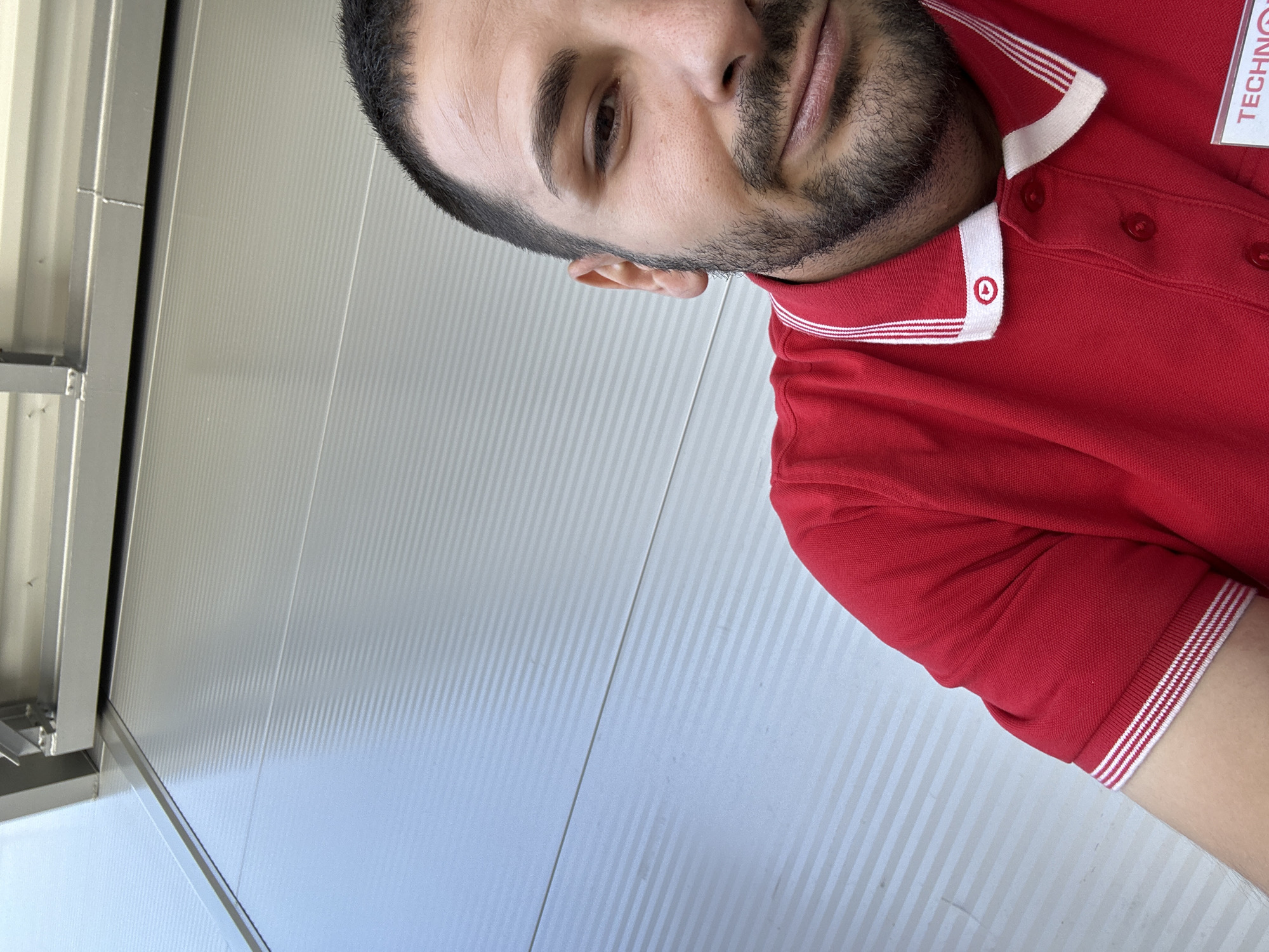 Man in red striped polo shirt observed at location