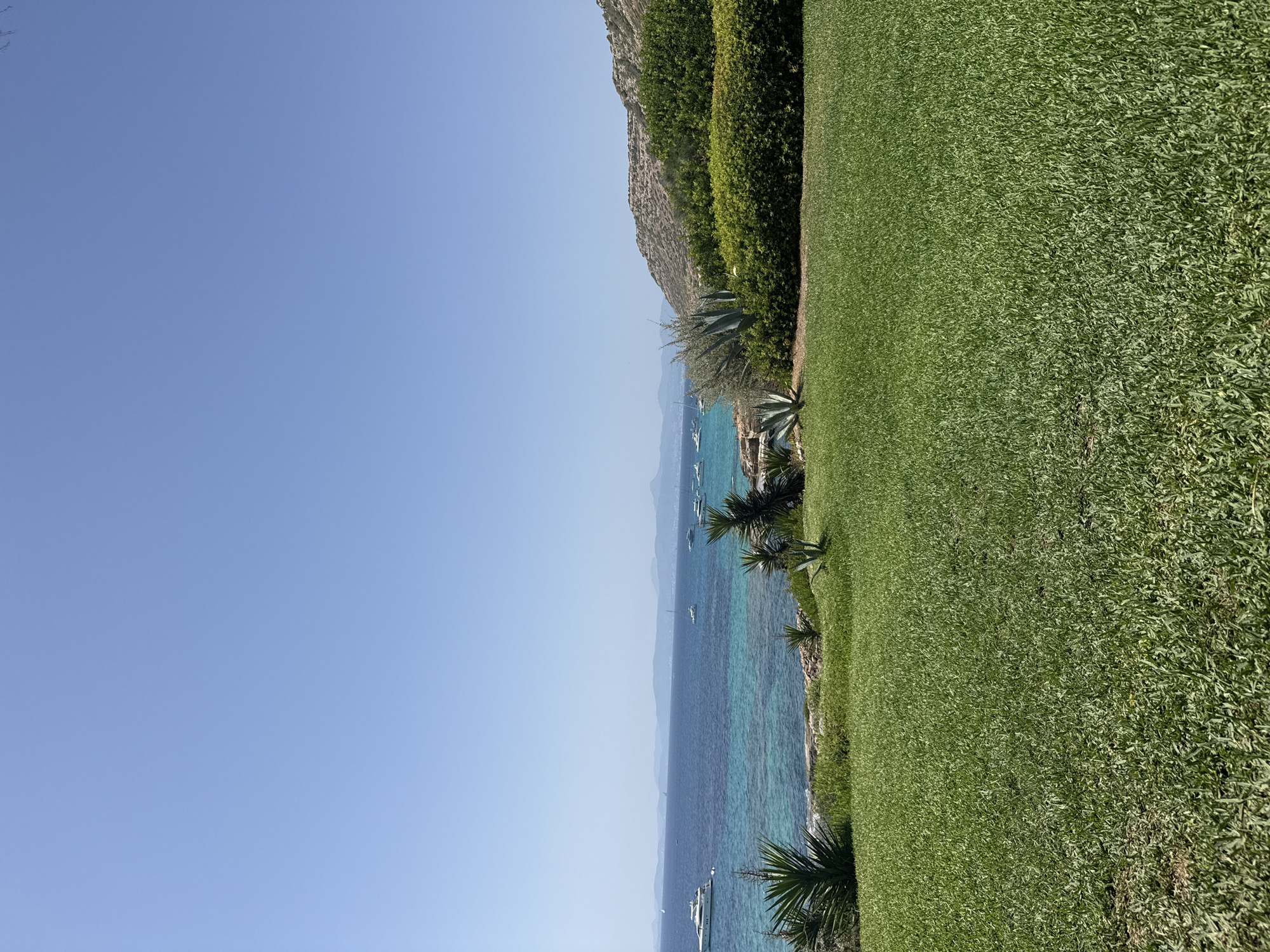 Coastal afternoon in Llucmajor — cliffs, yachts, and resort drinks