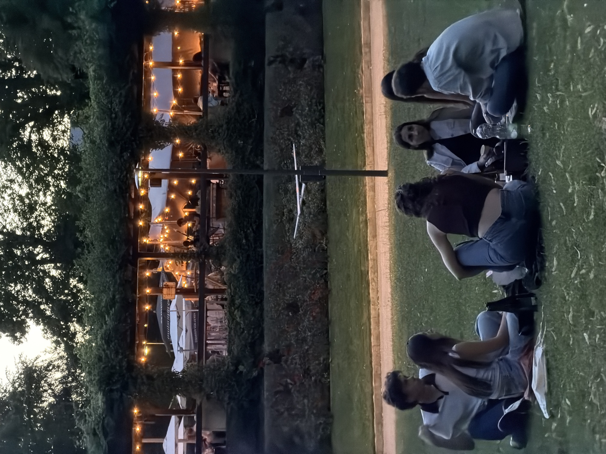 Evening gathering near an illuminated sculpture in Luxembourg City