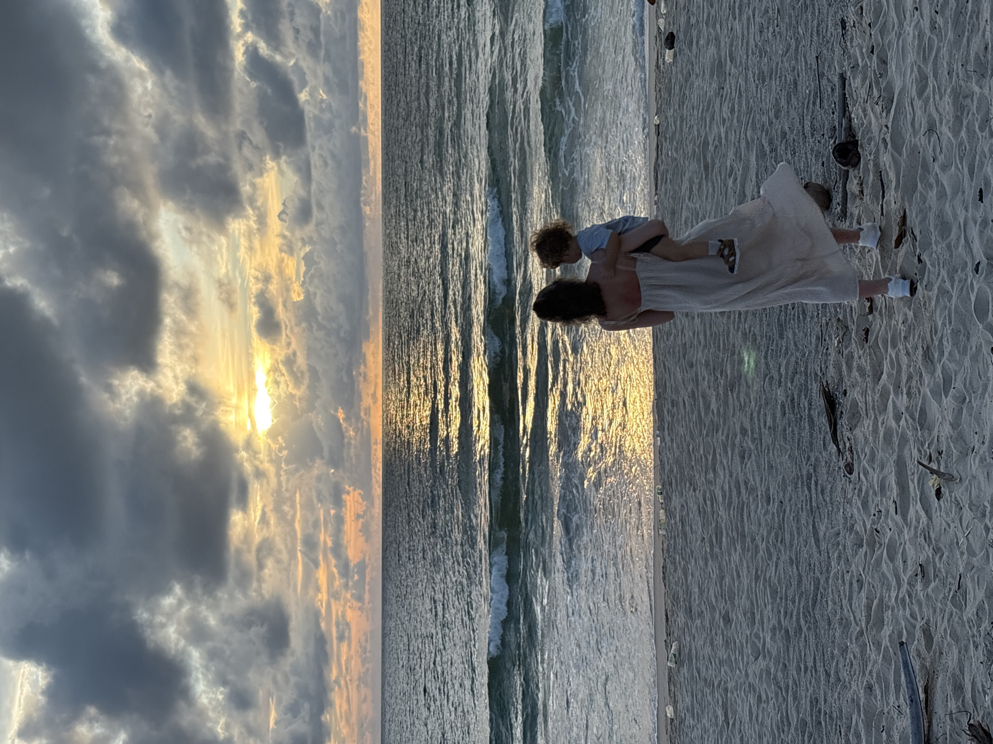 Beach moments in Choeng Thale — shoulders, sand, and sunset clouds
