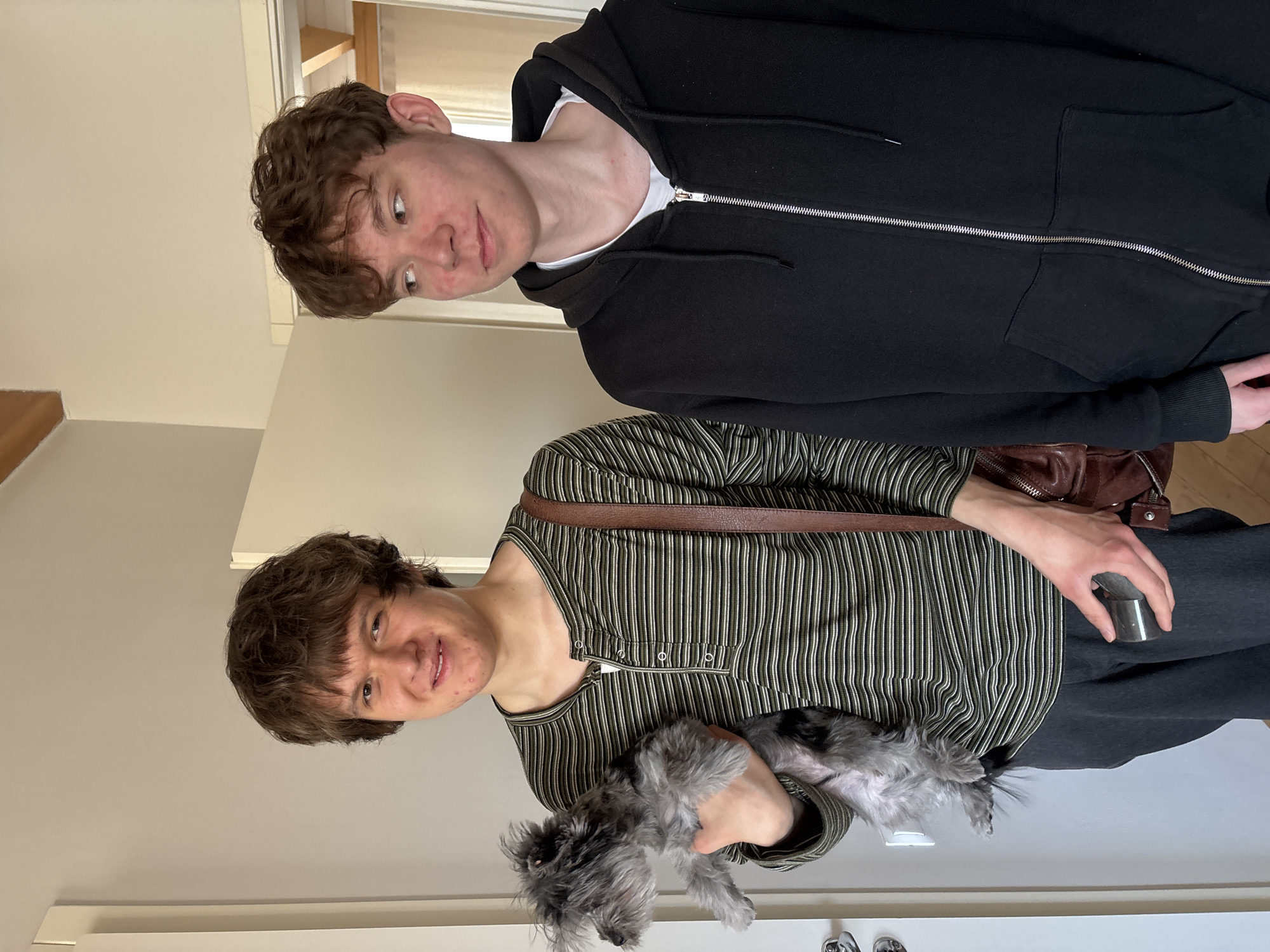 Two youths and dog captured in home interior, Chaikovsky