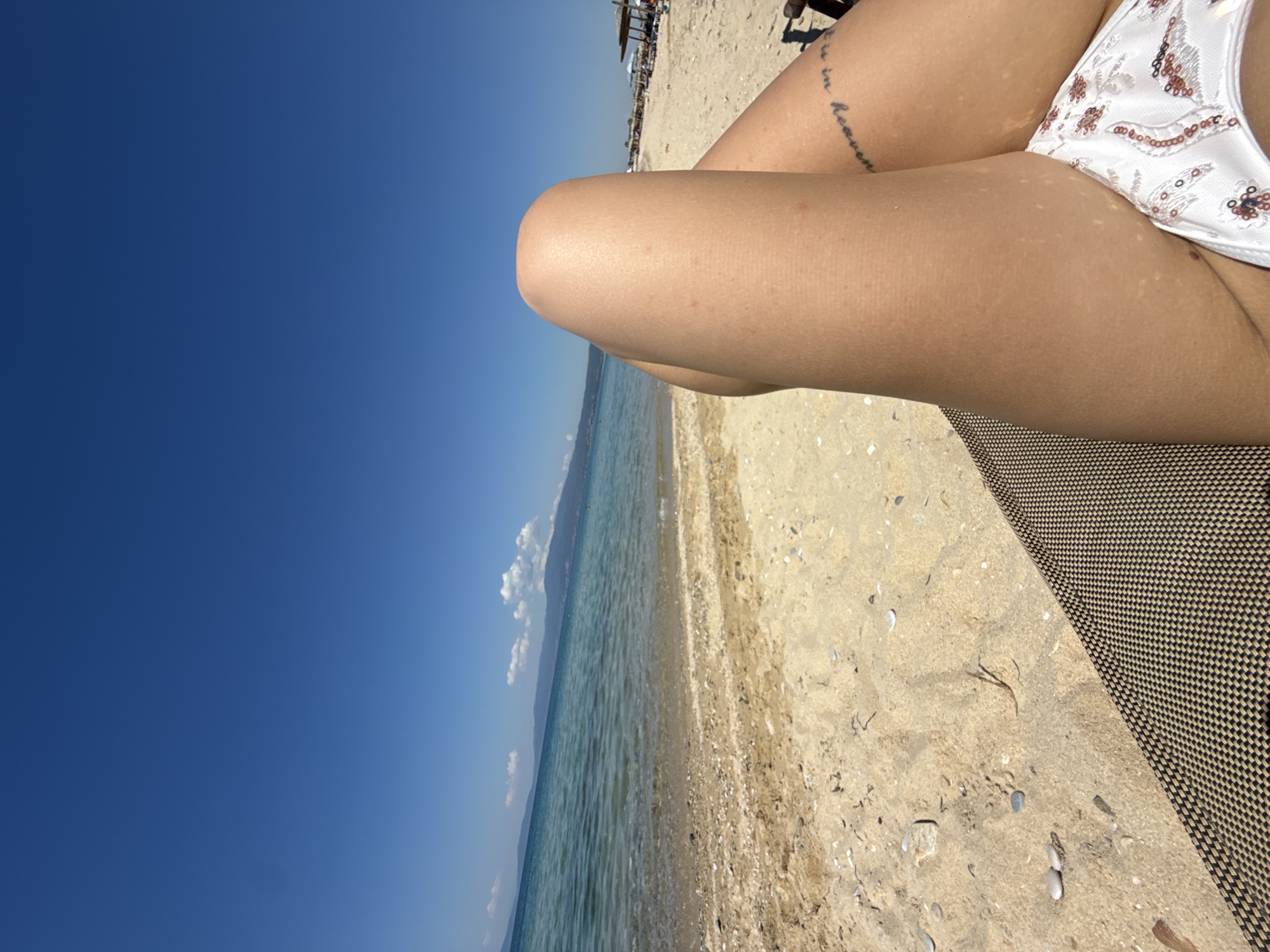 Woman relaxes in white bikini on beach chair