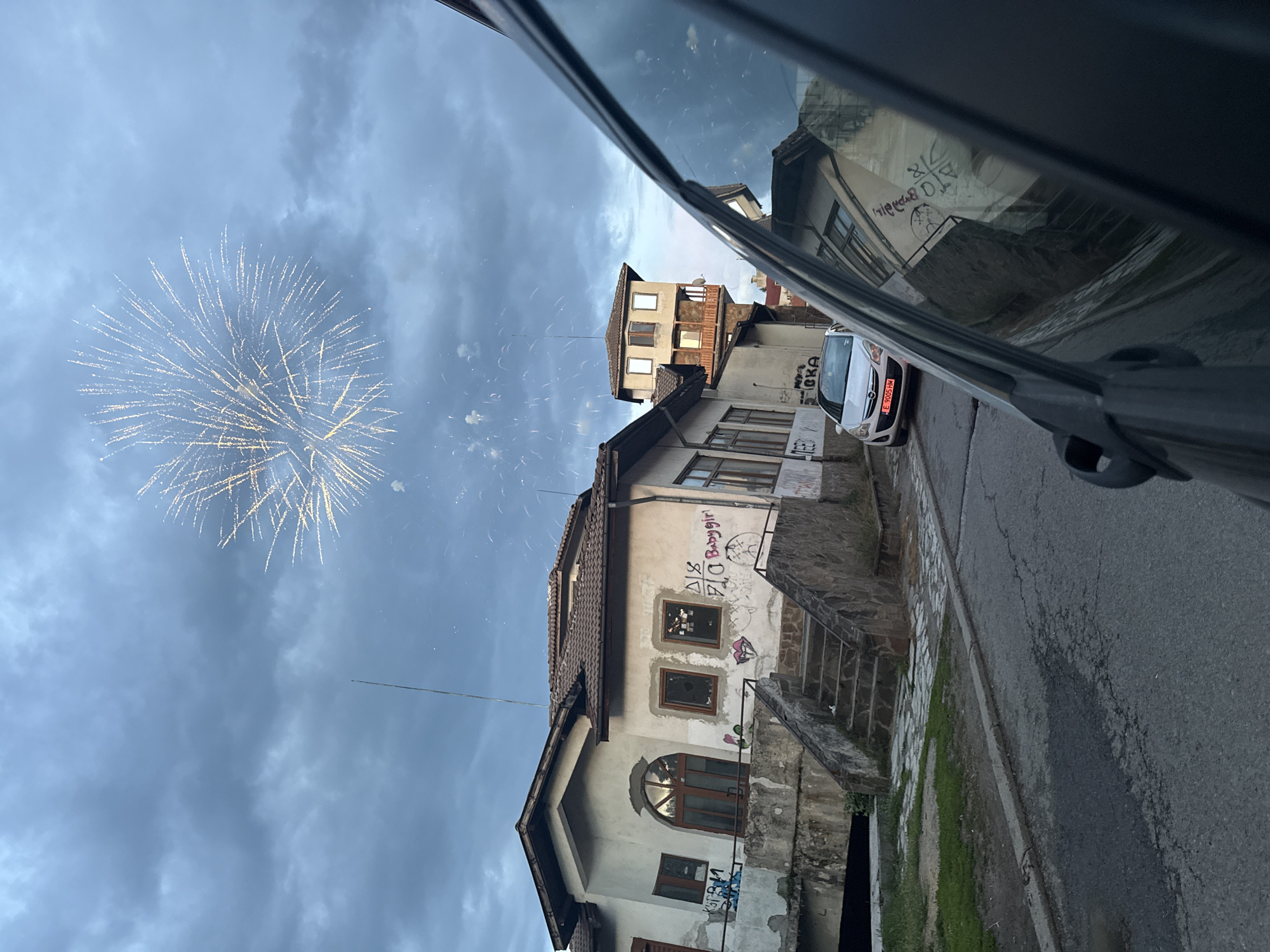 Firework spotted over weathered buildings in Razlog, Bulgaria