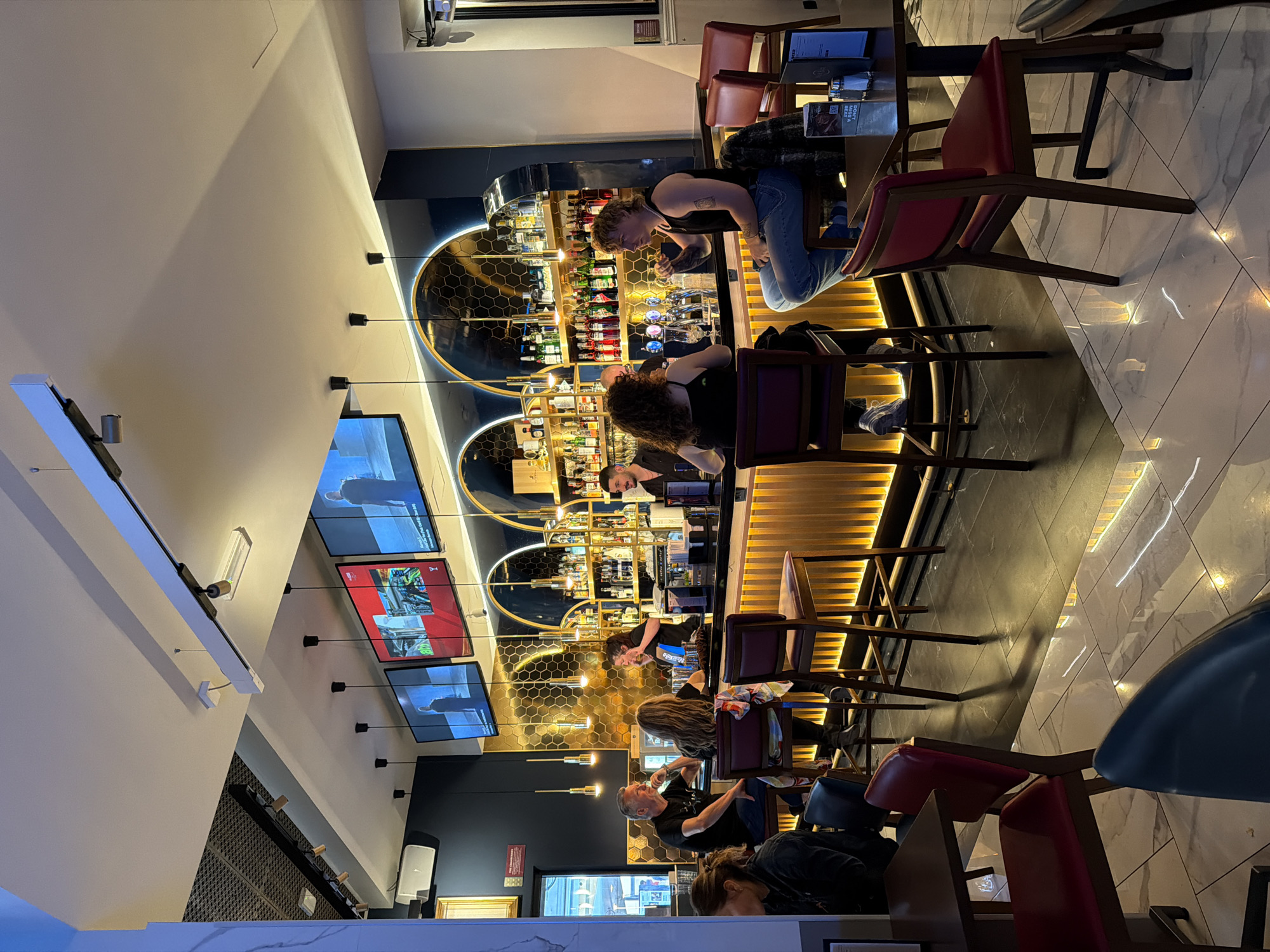Patrons drink and socialize at Milan bar Friday afternoon