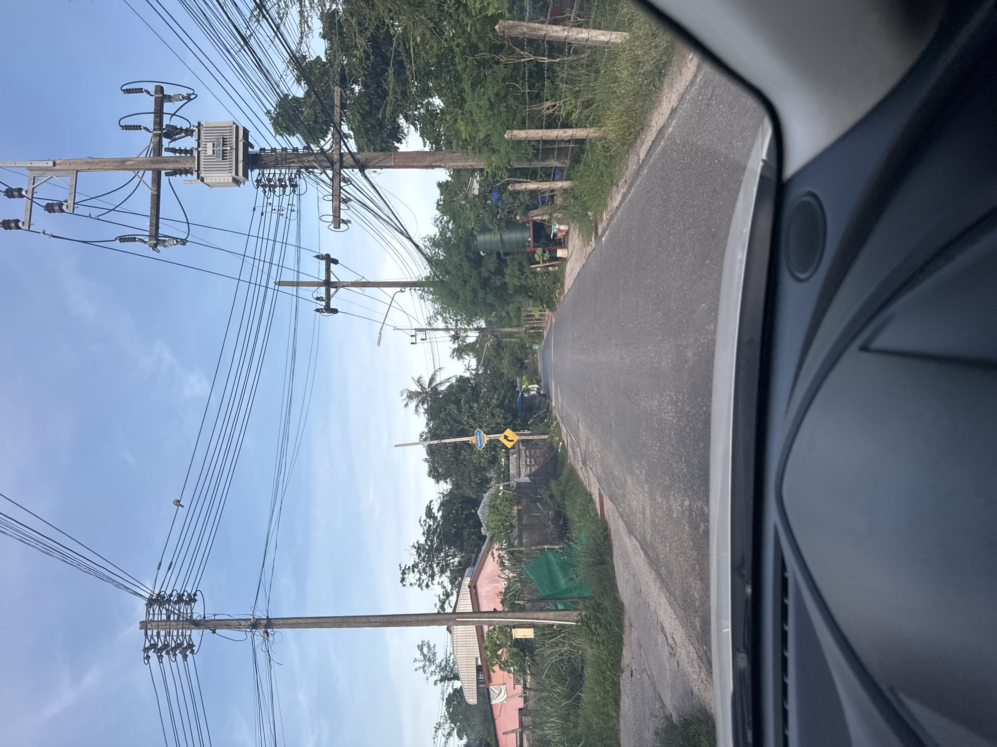 Vehicle journey documented through roadside scenes in Rawai, Thailand