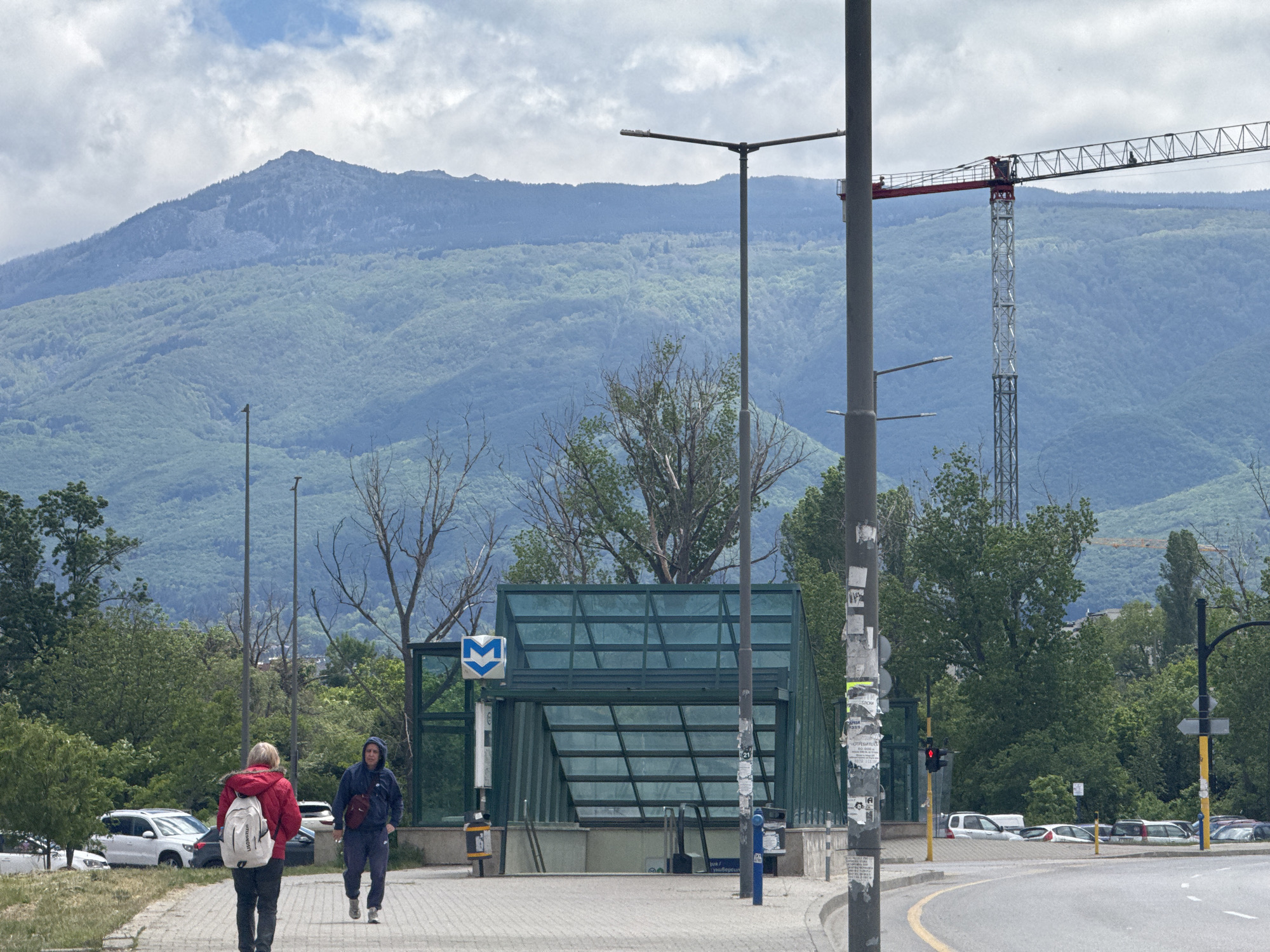 Pedestrians walk past Sofia metro station entrance