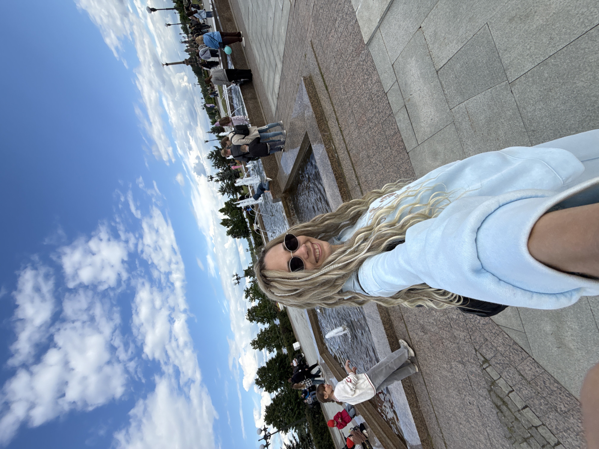 Woman photographs herself at fountain in Rusanovo, Russia