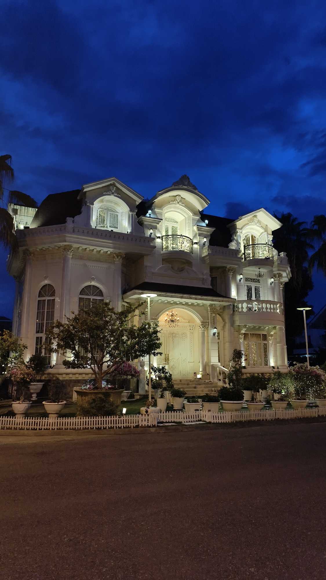 Ornate white mansion and Nha Trang coastline at night