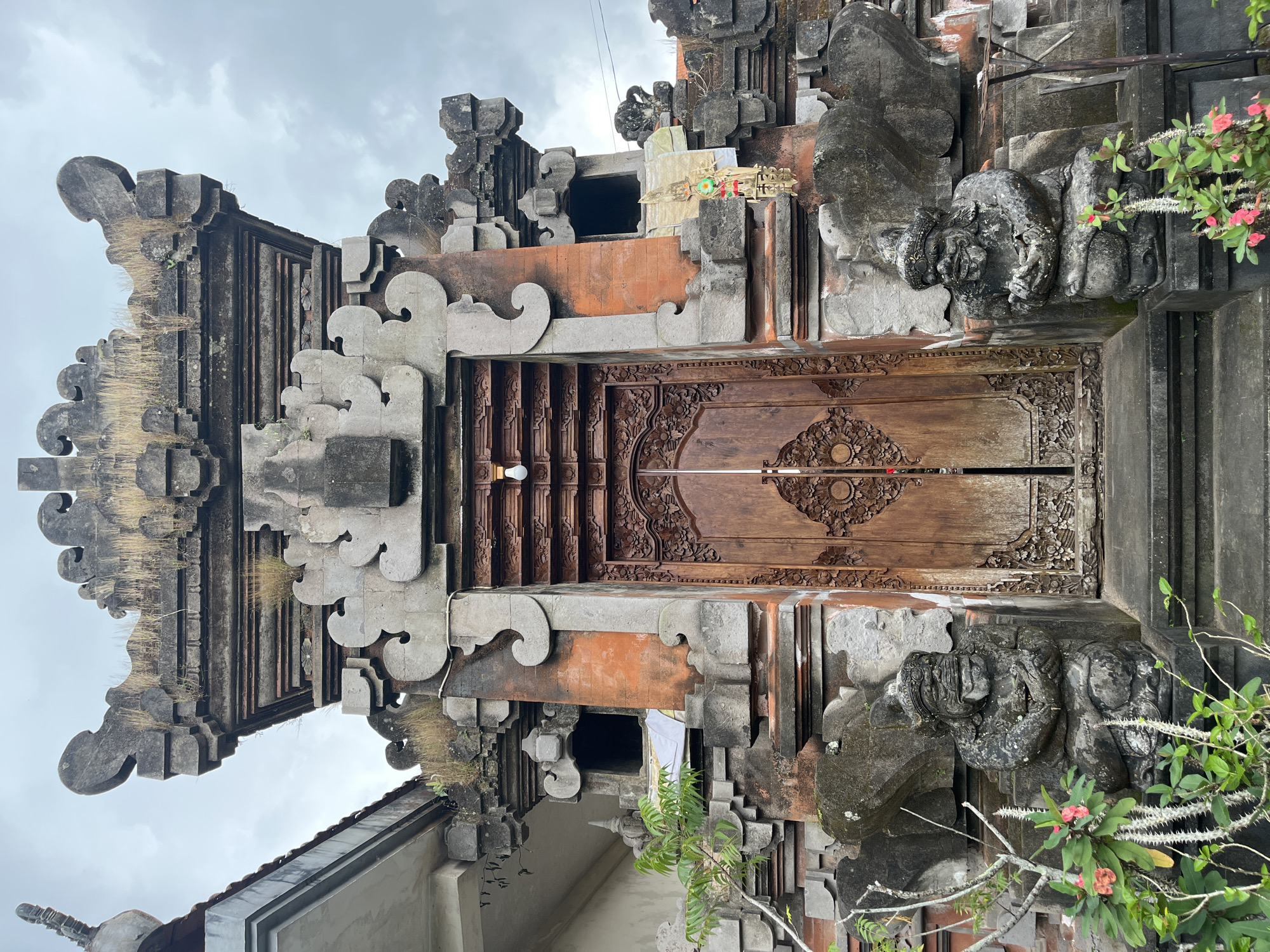 Tourist documents traditional Balinese stone architecture in Tegallalang