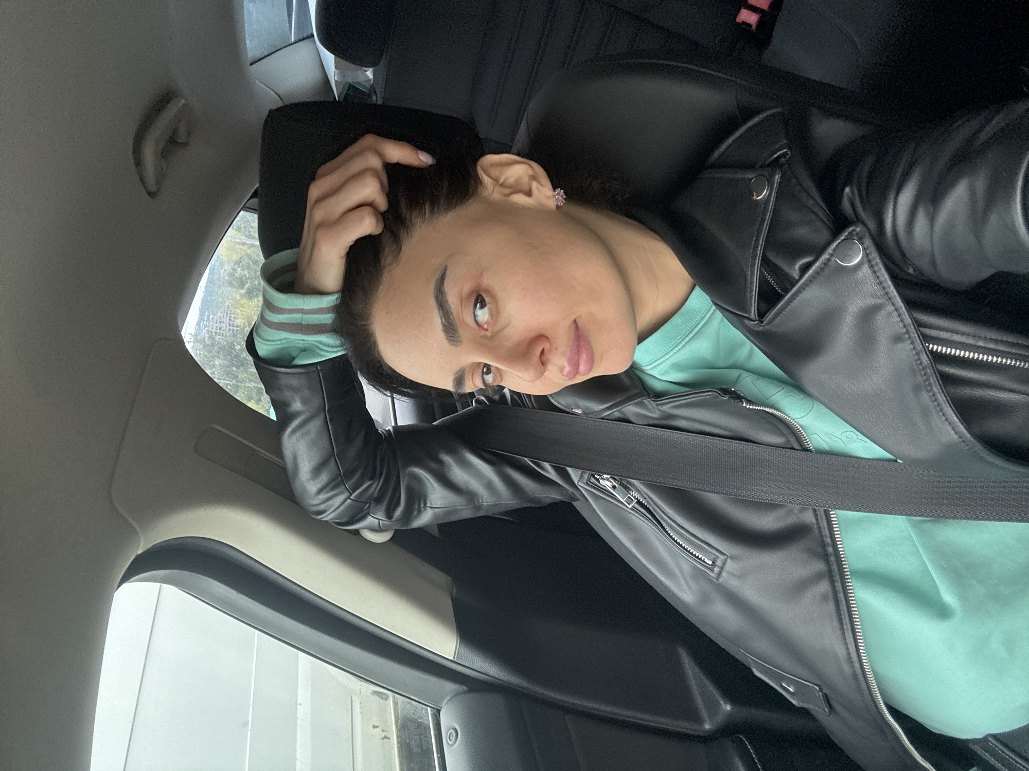 Woman photographed during car journey through Tbilisi traffic