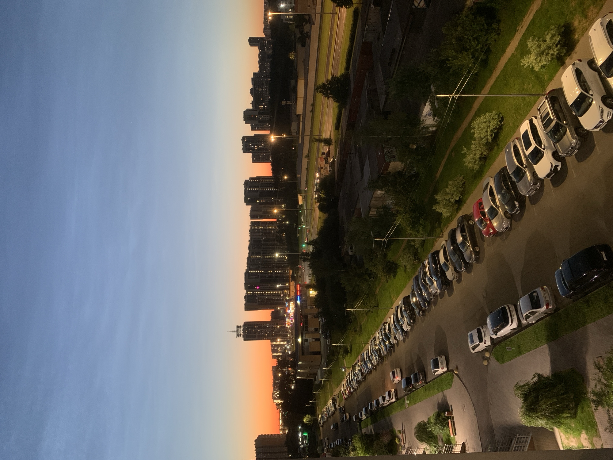 Dusk to nightfall over a dense urban neighborhood from above