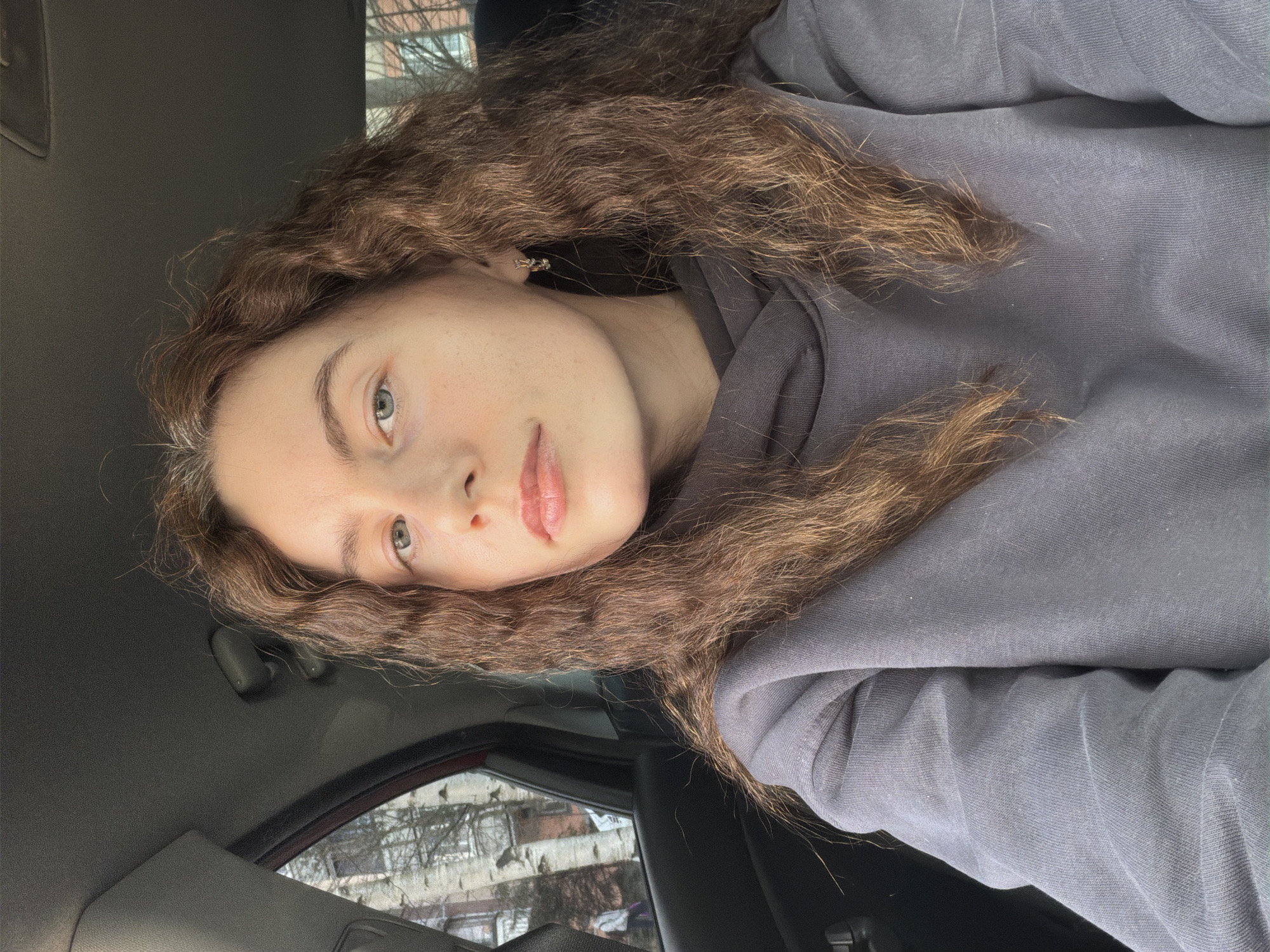 Woman takes car selfies in Vsevolozhsk residential area
