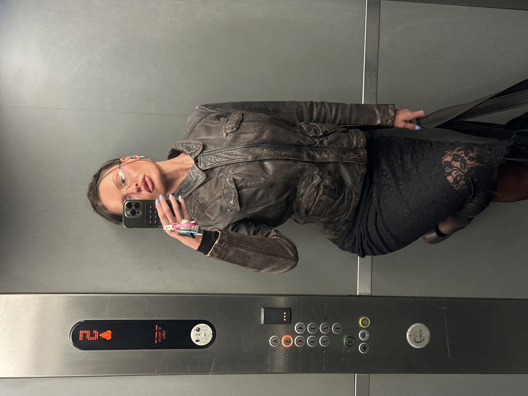 Woman takes elevator selfie in London