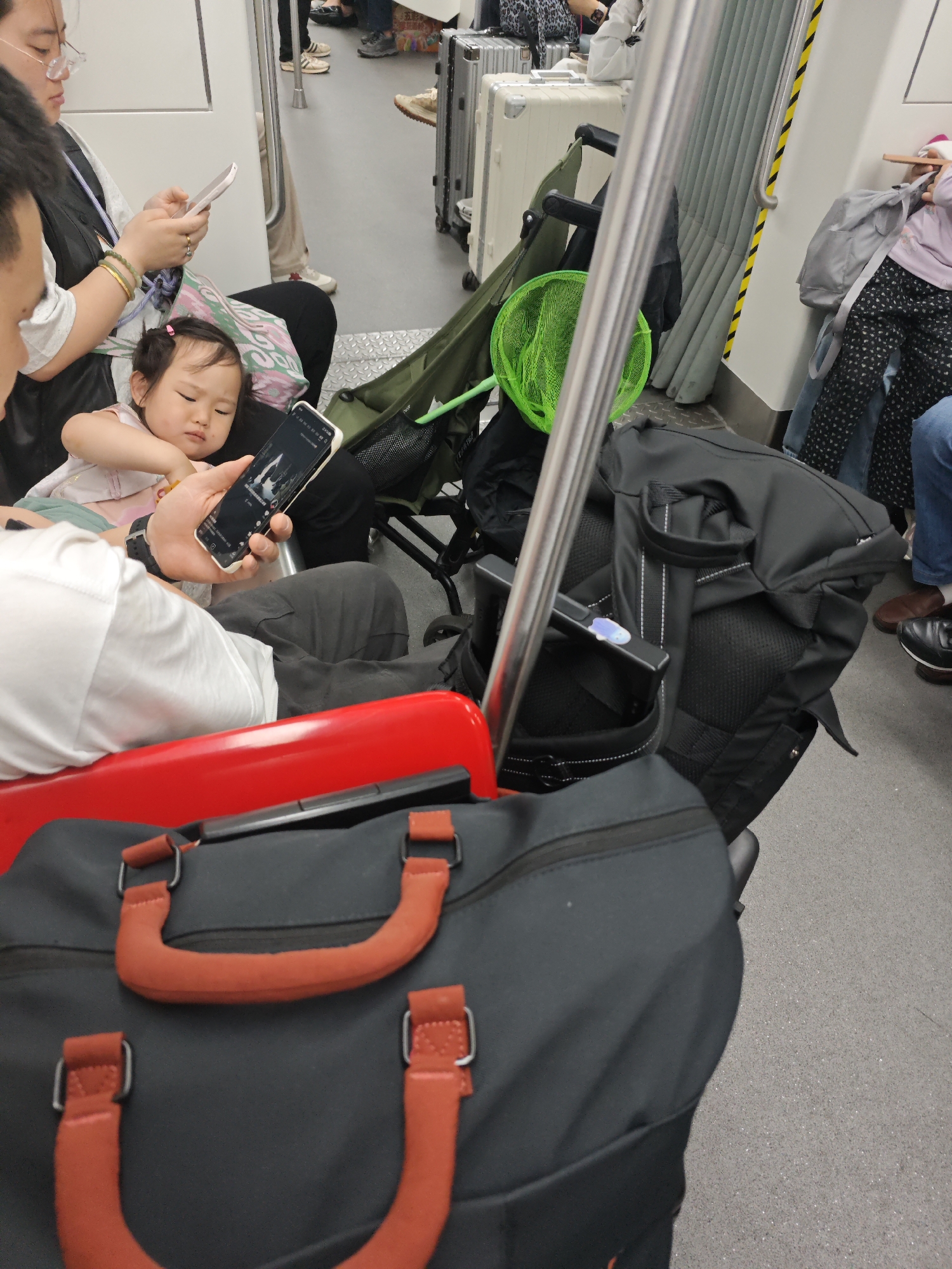 Child shares smartphone with adult during public transit journey