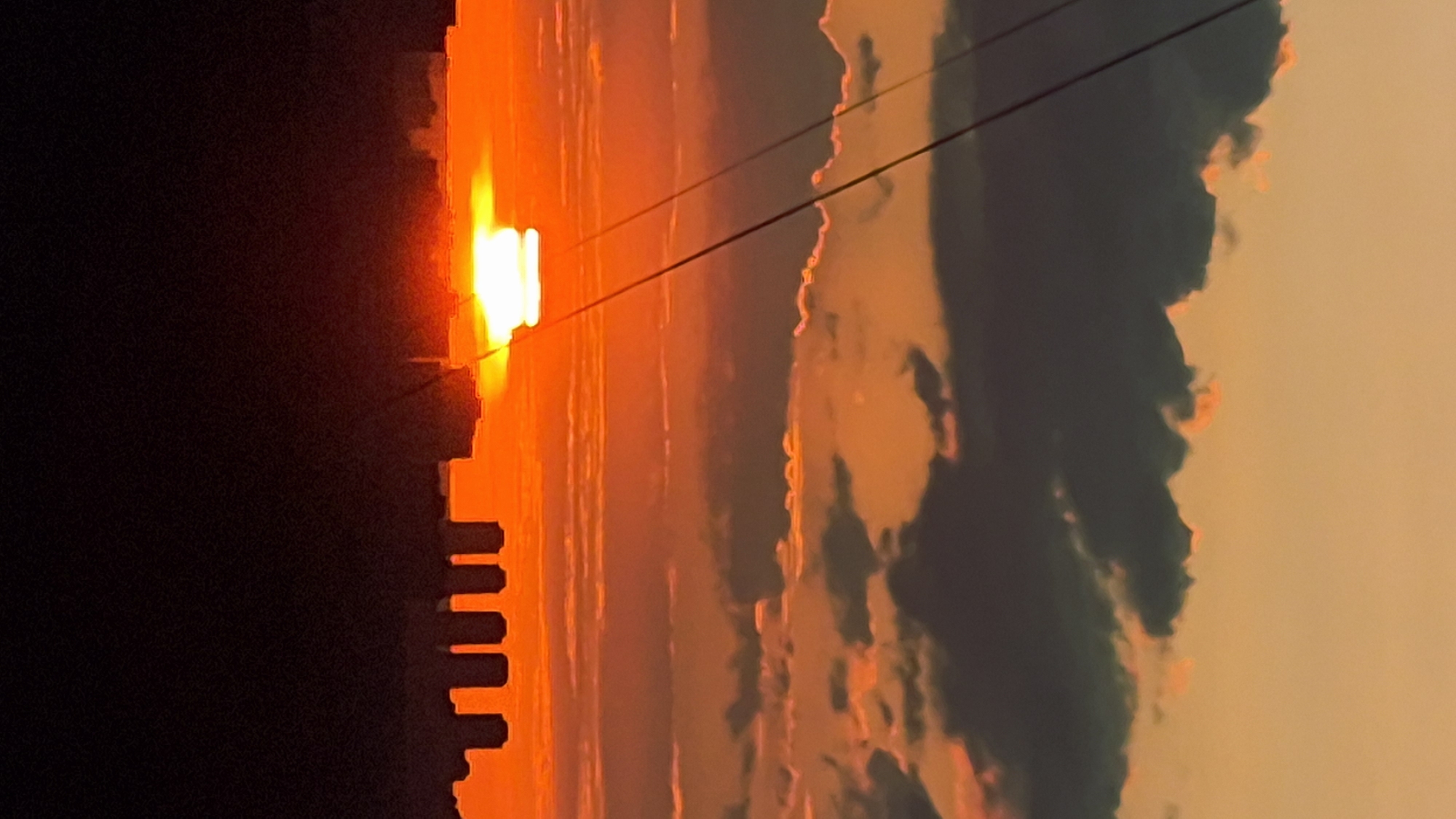 Two-angle sunset over an unidentified city skyline