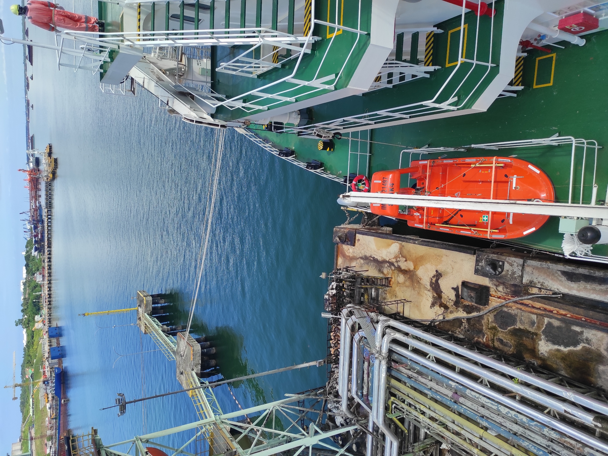 Industrial port operations with docked cargo ship