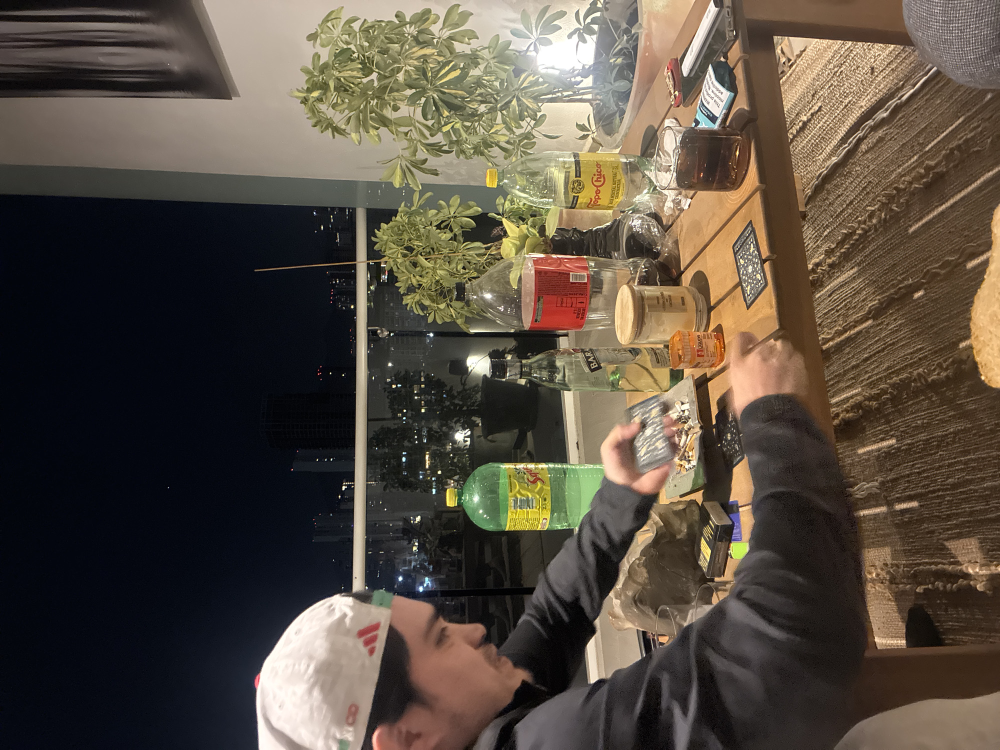Man with cards at table during nighttime indoor scene
