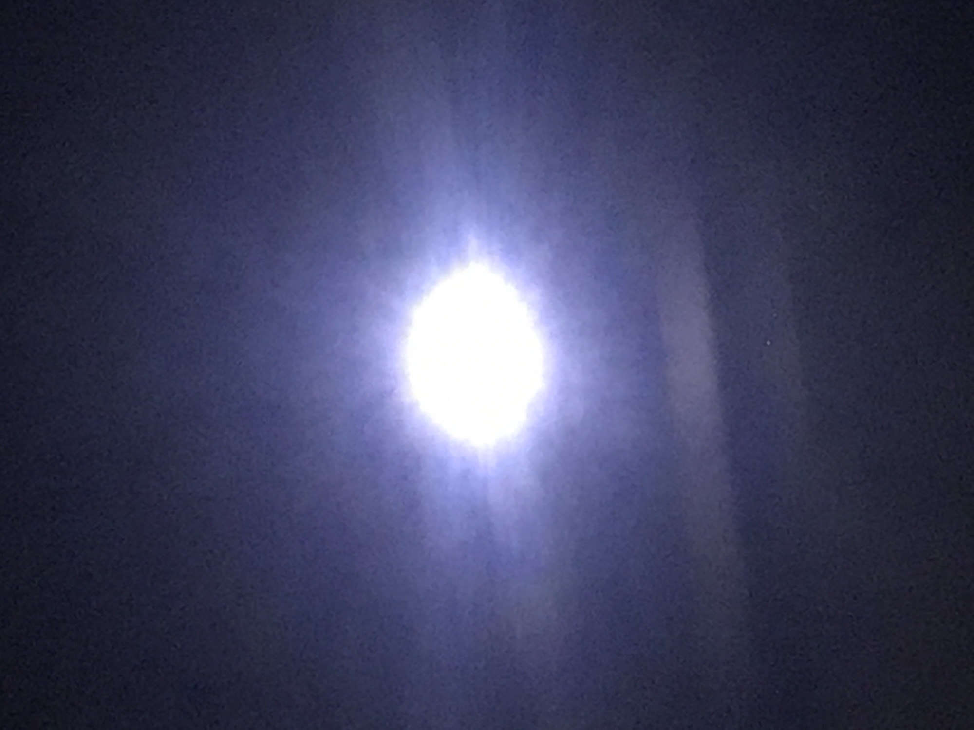 Witness captures bright celestial body with halo in night sky