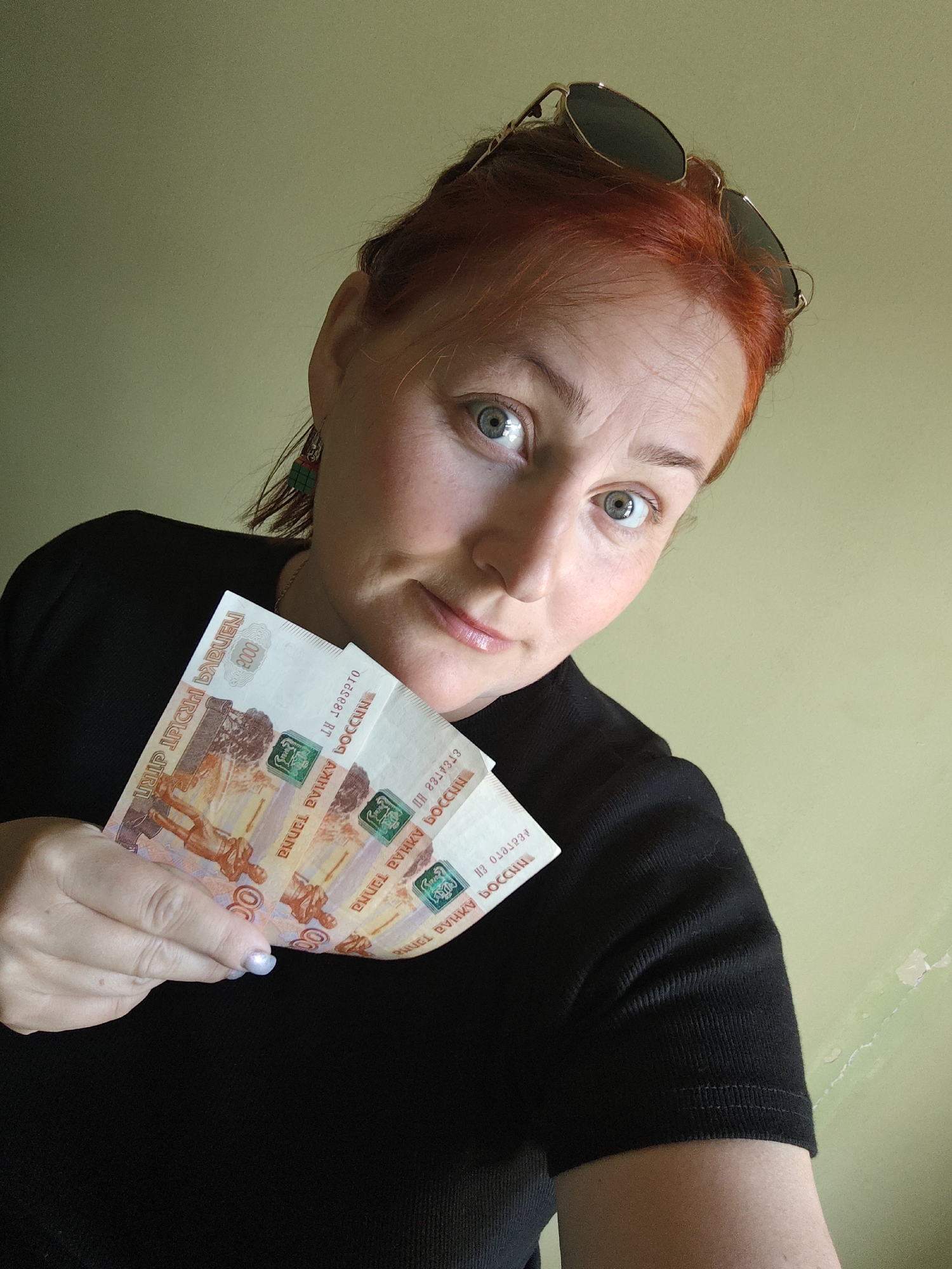 Woman holds Russian currency banknotes in Markovskiy