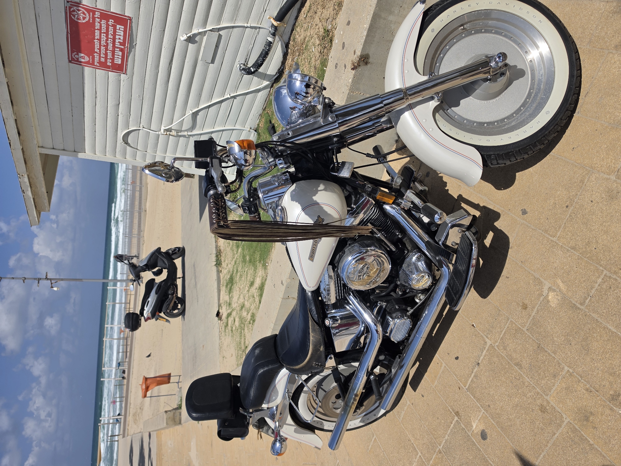 Harley-Davidson motorcycle parked near Mediterranean beach in Bat Yam