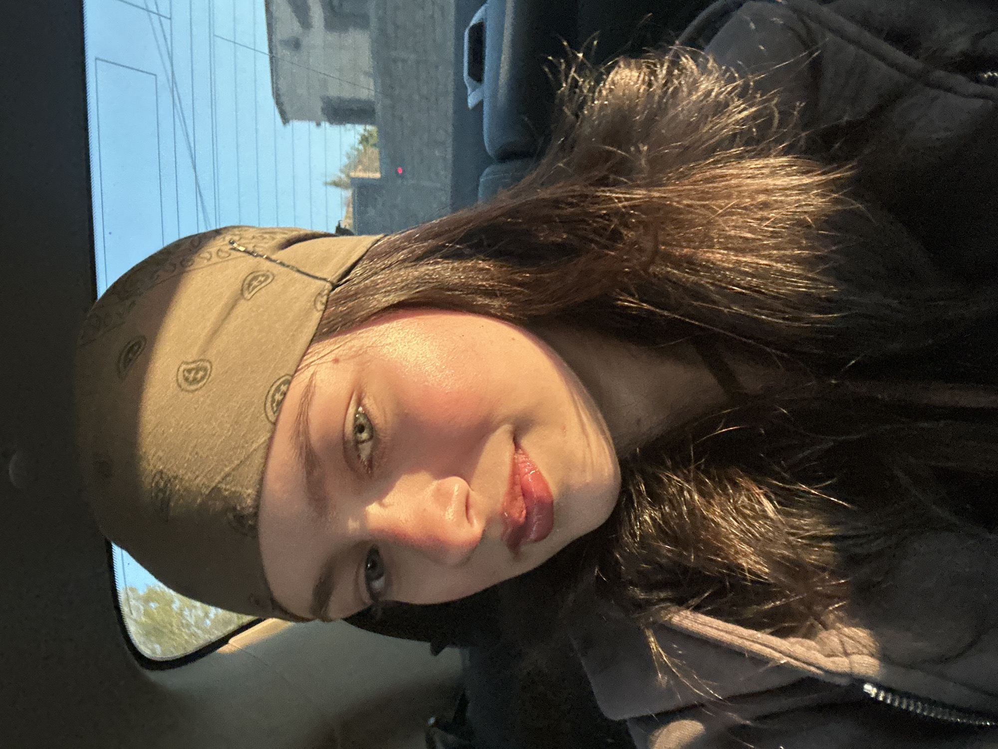 Young woman documents afternoon car journey through Yerevan selfies