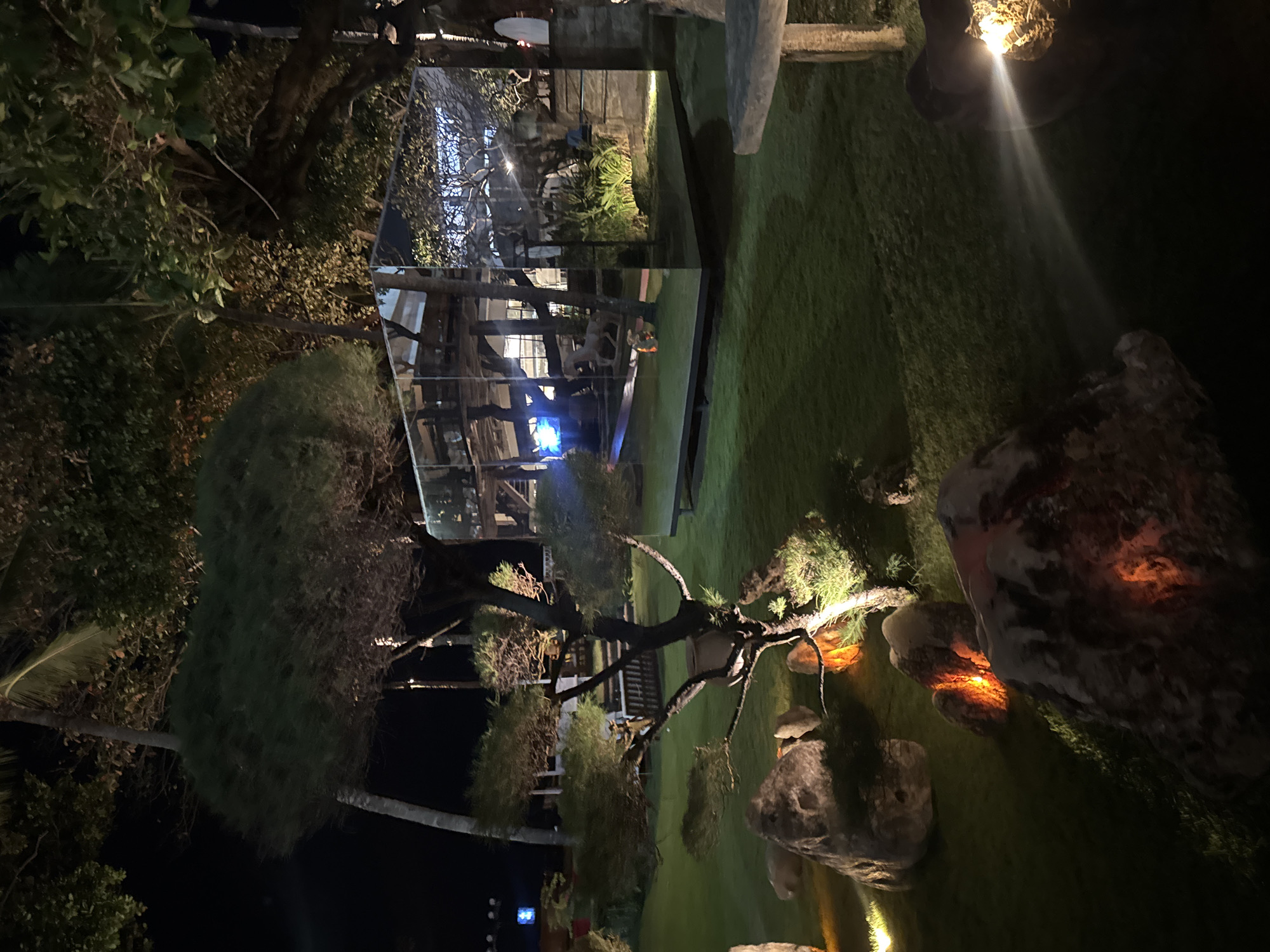 Lit gardens and stone sculptures at a North Kuta night attraction