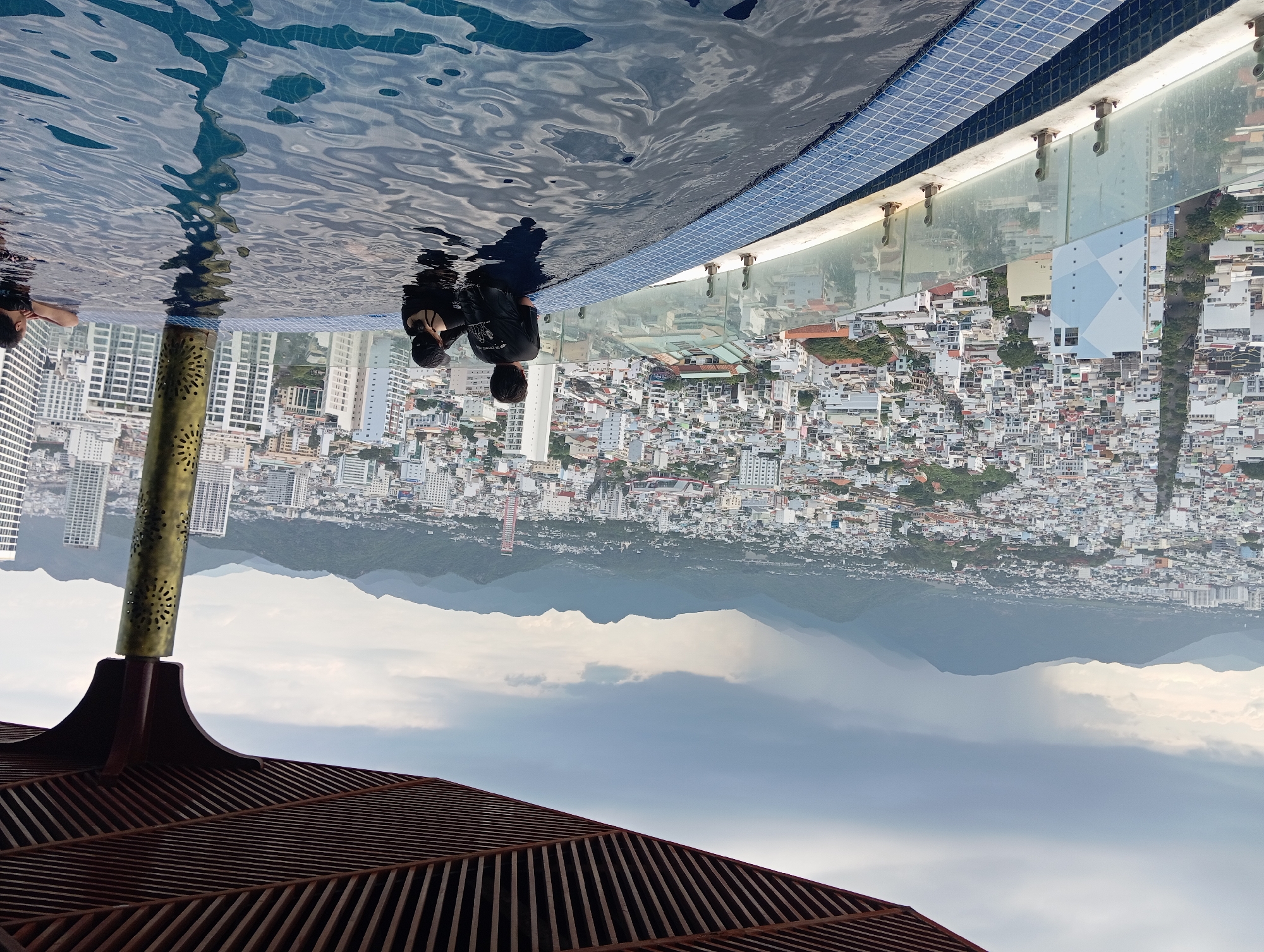Rooftop pool views and street stalls in Nha Trang