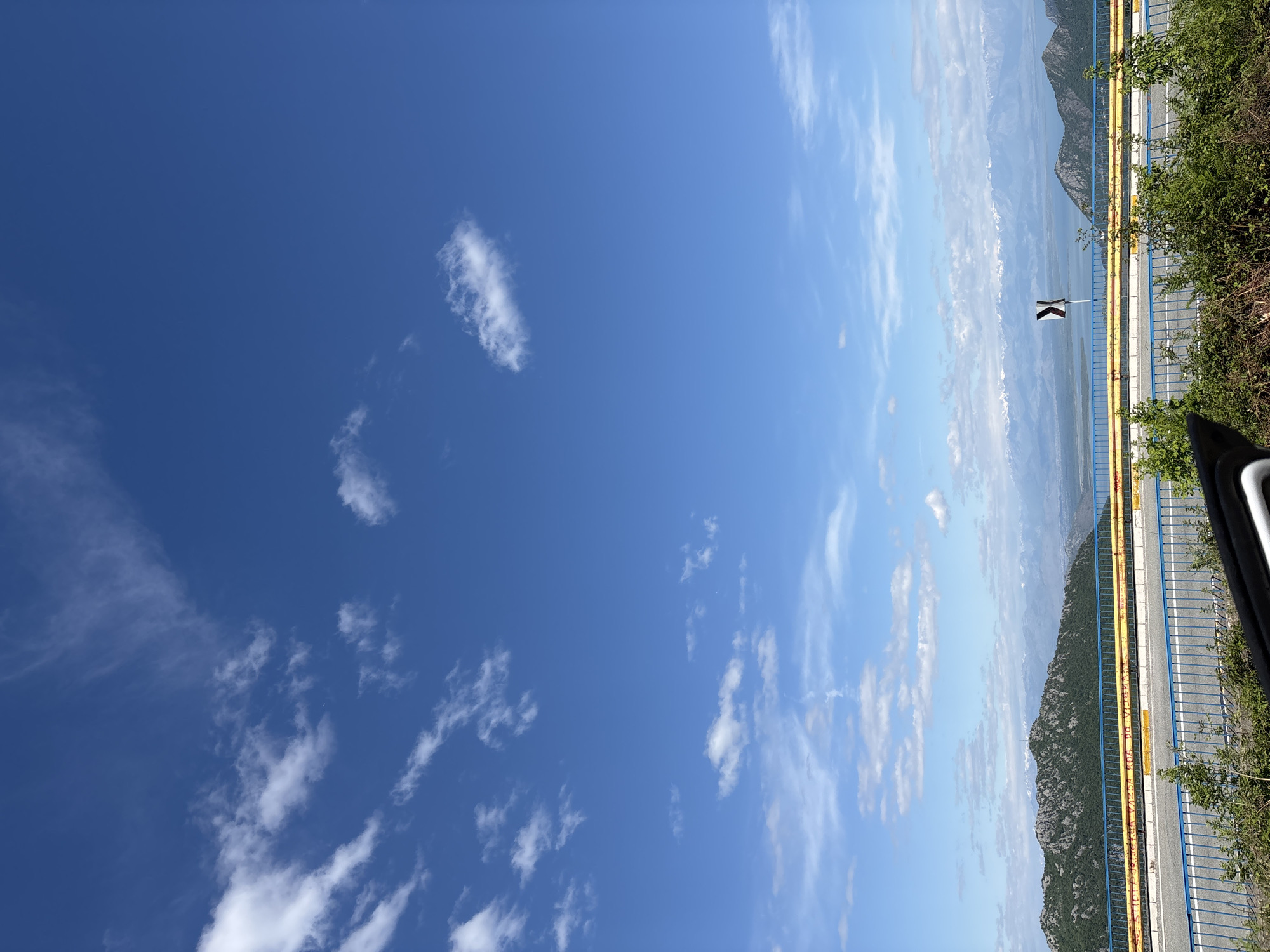 Clear blue sky with scattered clouds observed outdoors