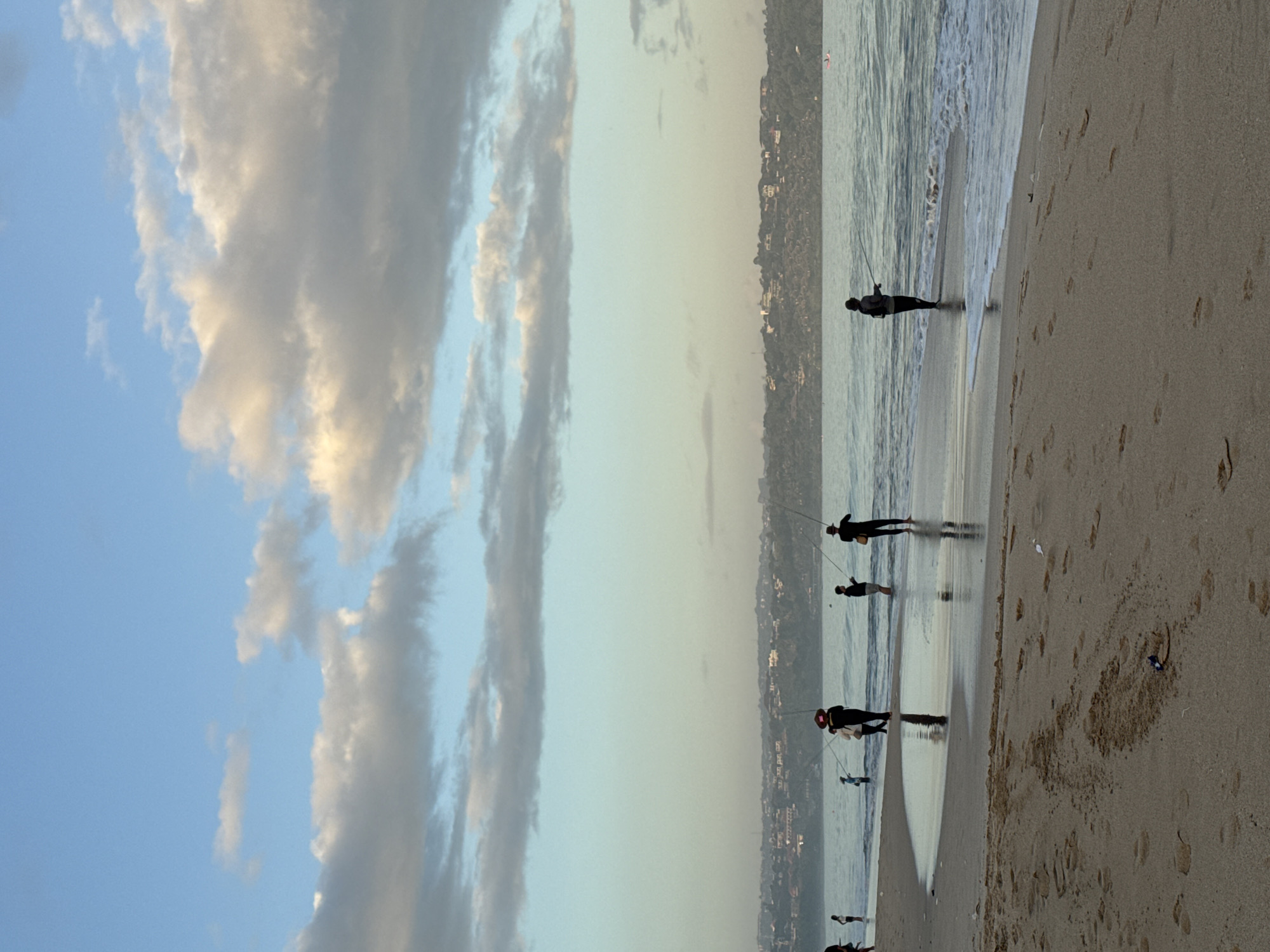 Evening fishing and beach activity observed in Kuta