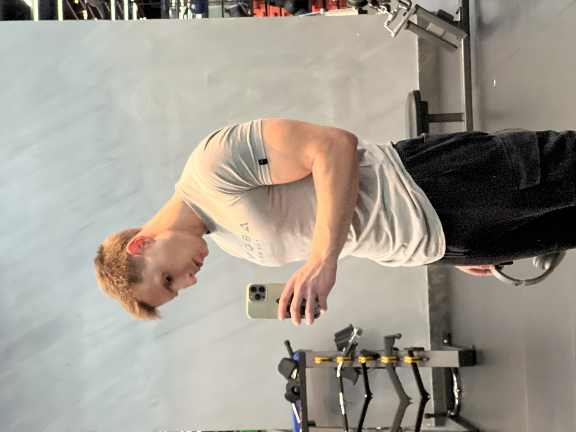 Man uses phone at Burgas gym during afternoon workout