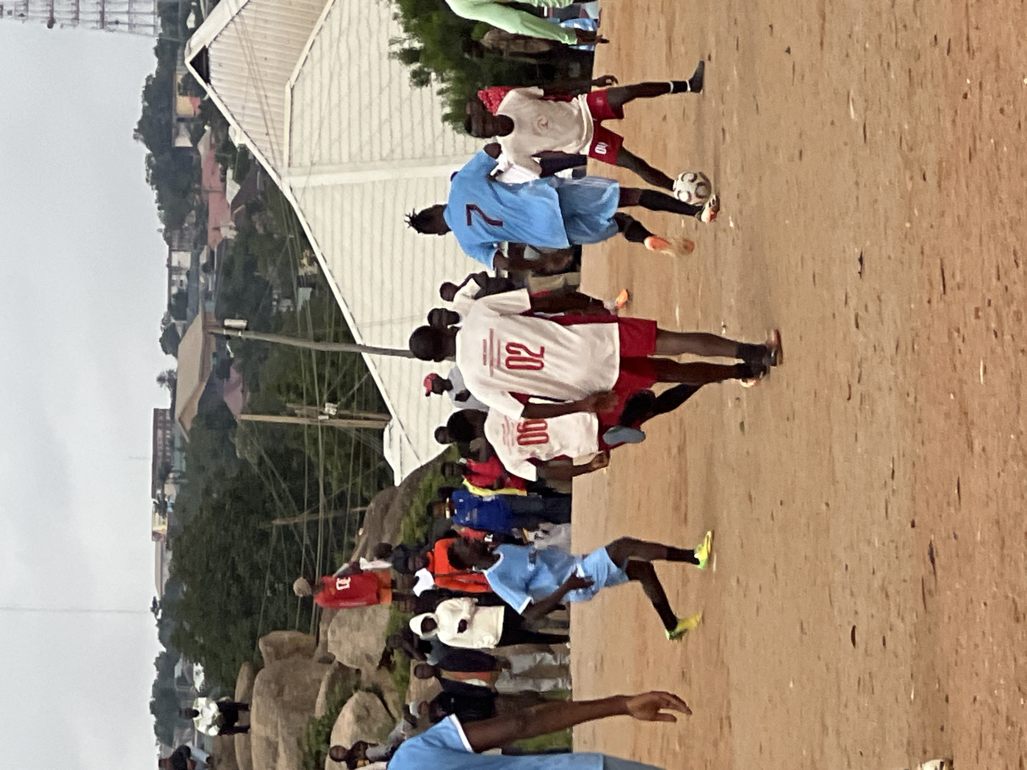 Pickup soccer on a rocky dirt pitch in Jos, Nigeria