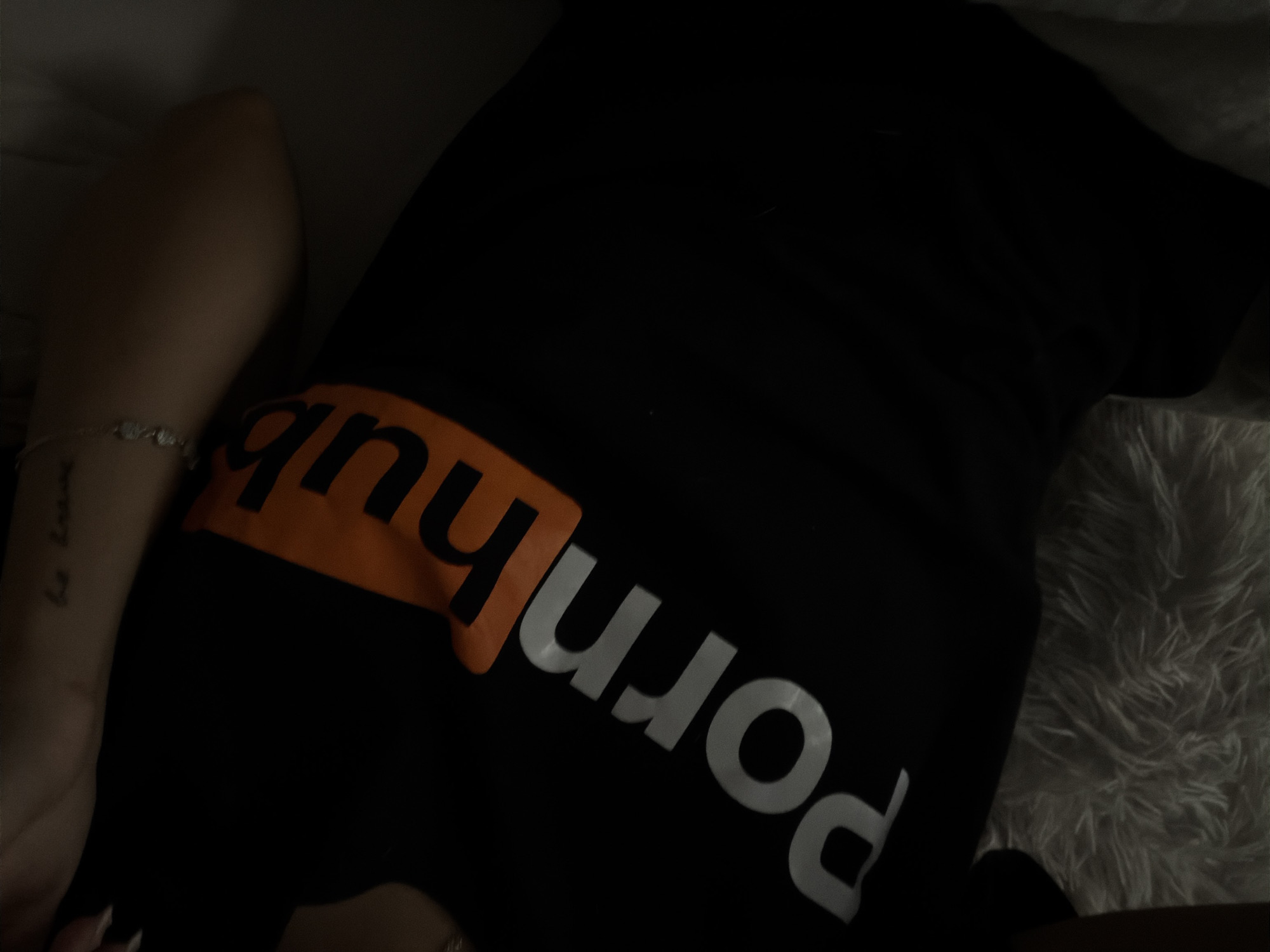 Person in branded t-shirt resting indoors in Sofia