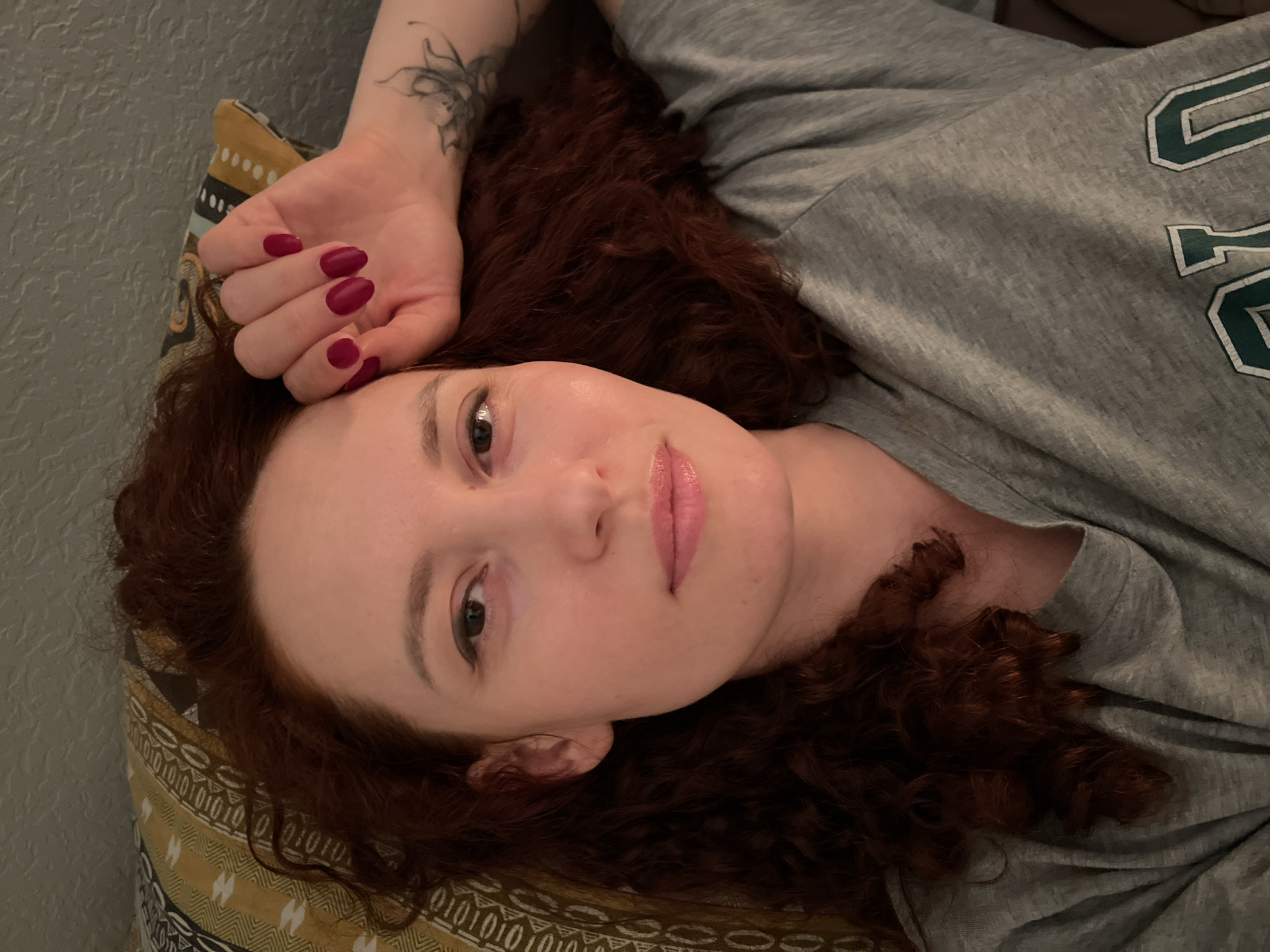 Woman rests in bed during evening hours in Saint Petersburg