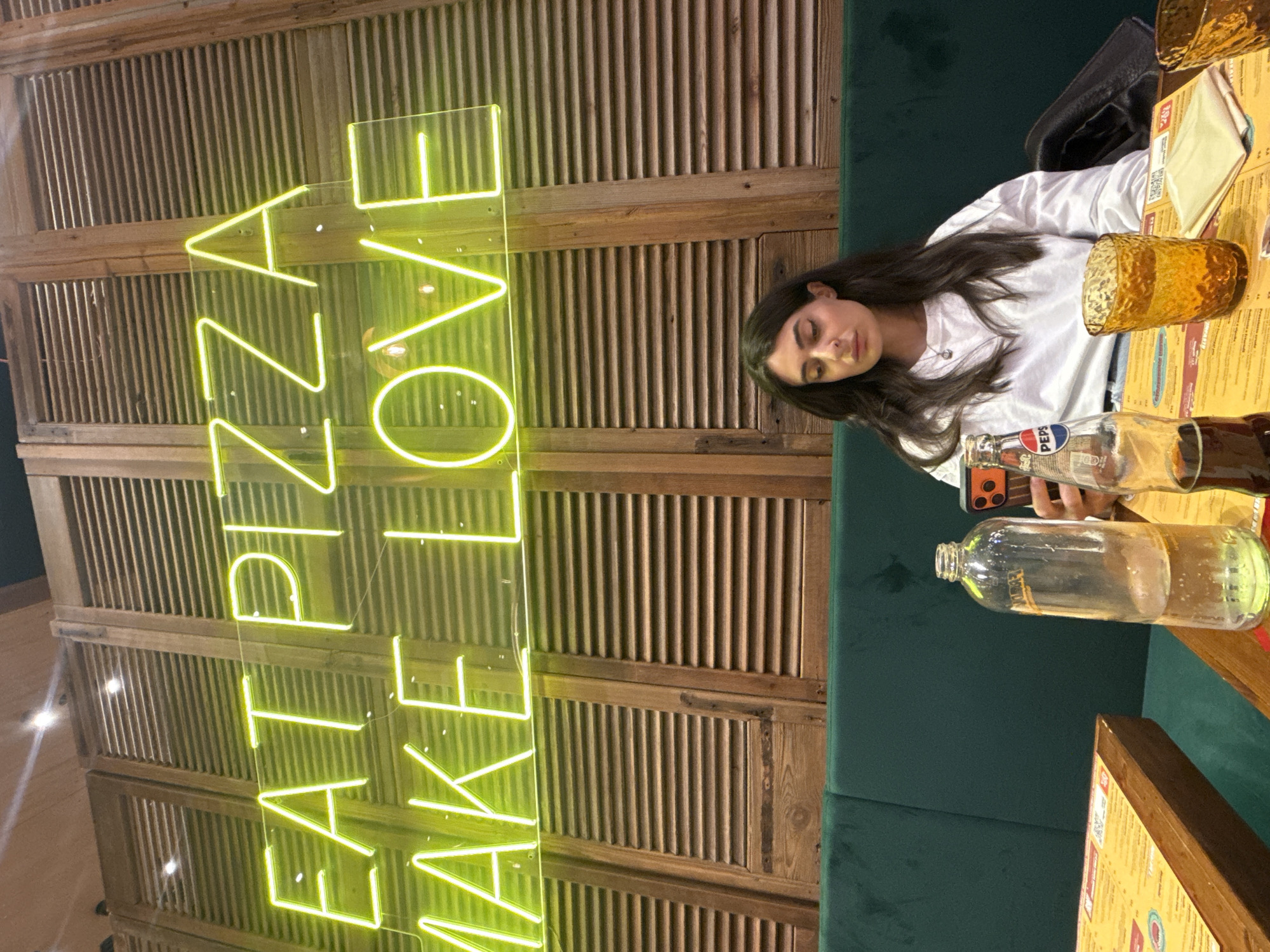 Woman rests at Milan pizza restaurant during evening dining