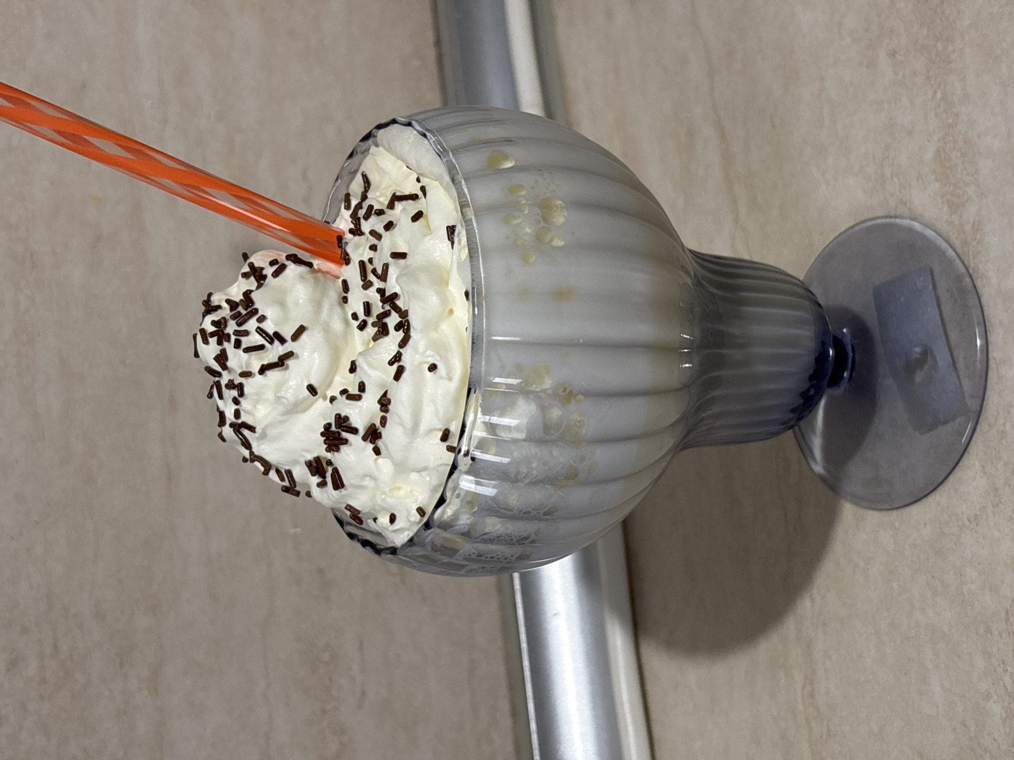 Milkshake with whipped cream and sprinkles documented