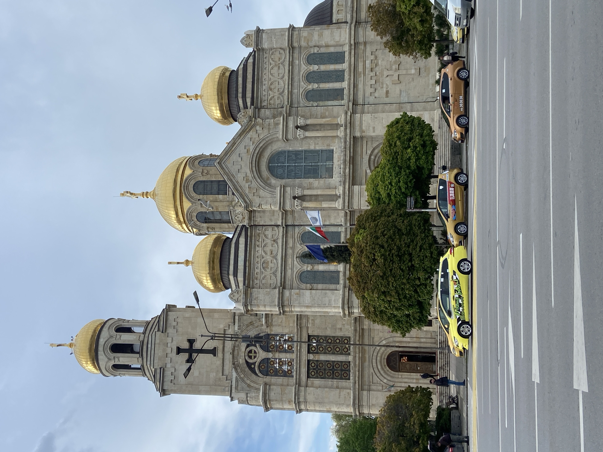 Street scenes documented in unidentified city, cathedral visible