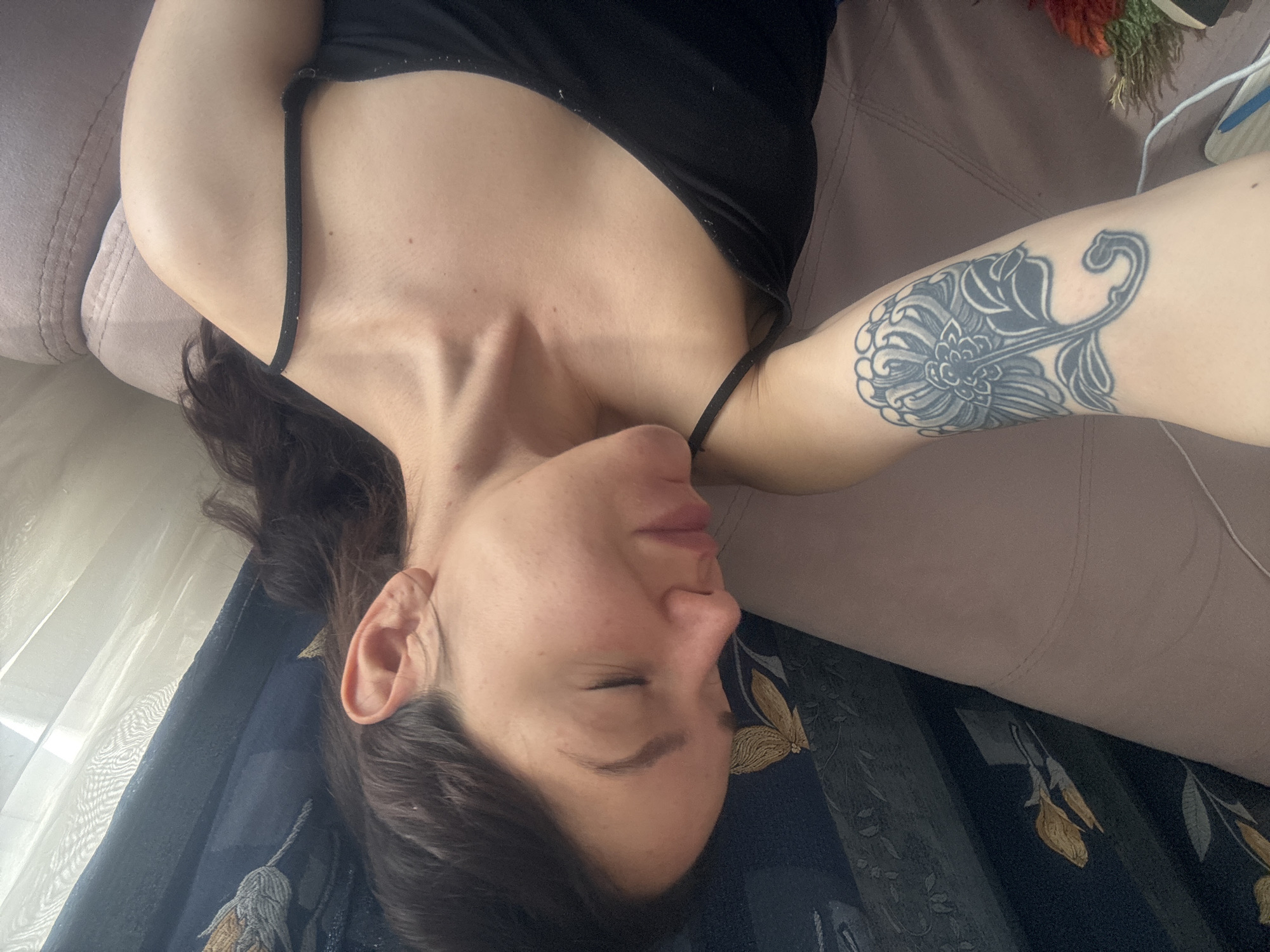 Woman rests on couch in Burgas indoor setting