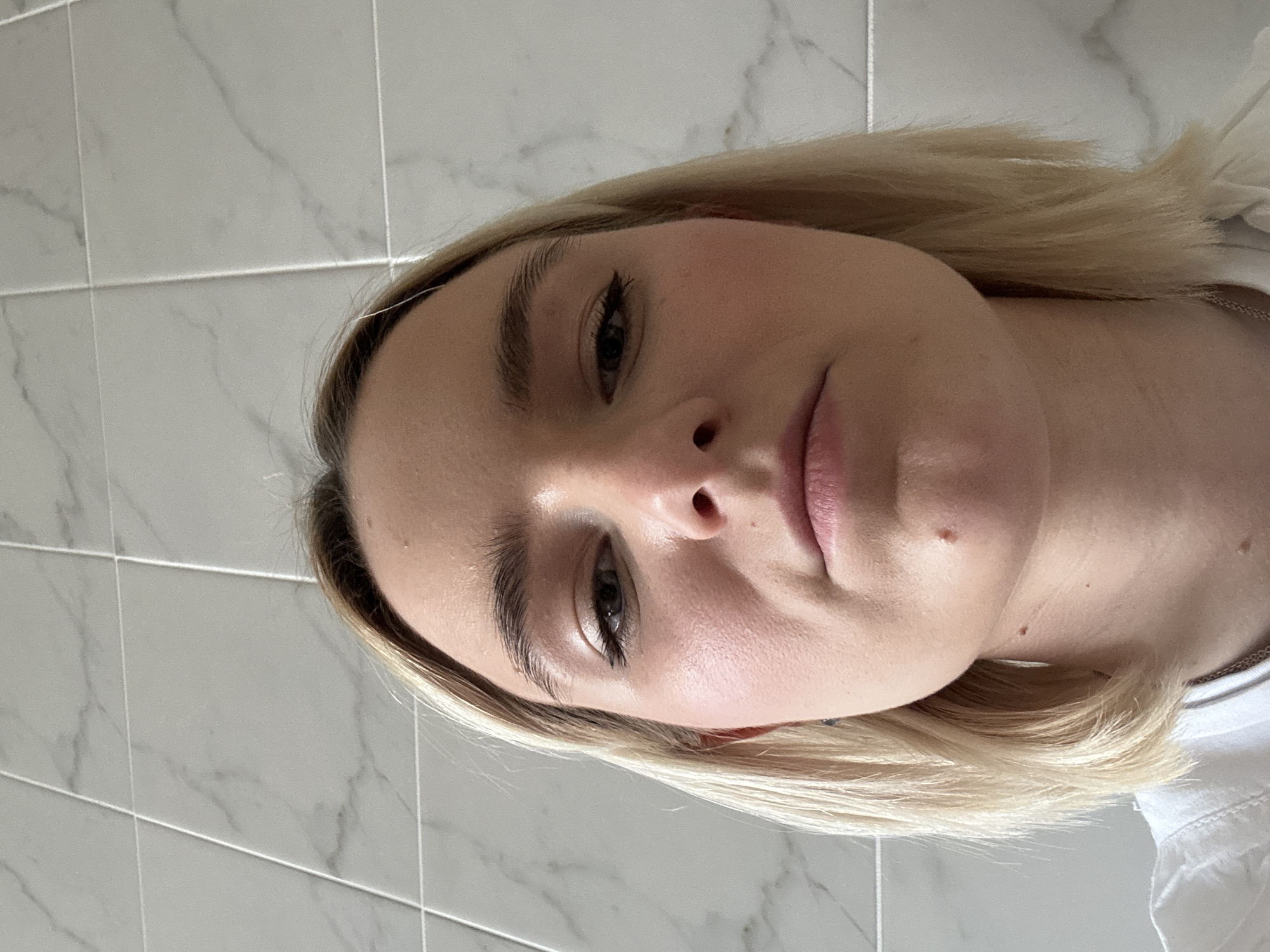 Person takes close-up selfies in Saint Petersburg bathroom