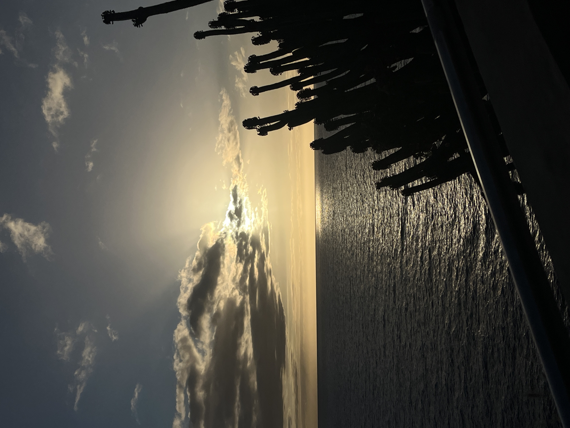Clouded sunset observed over water in Mogán, Spain