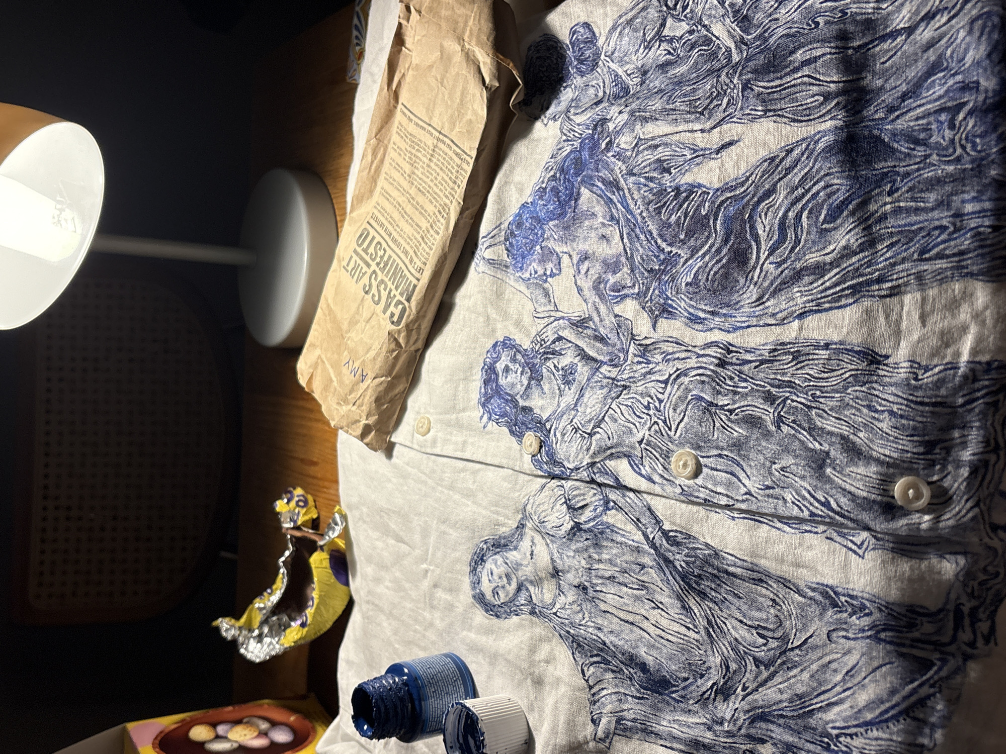 Desktop scene with lamp, chocolate wrapper captured in Manchester
