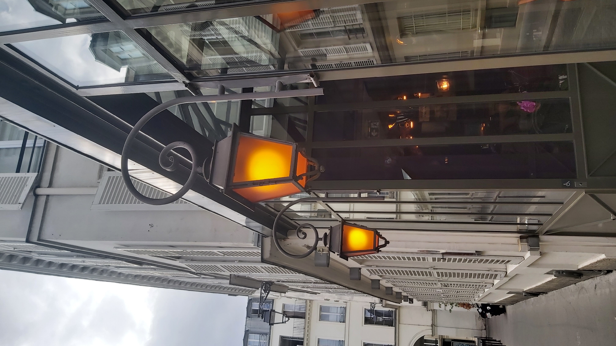 Street-level and rooftop views across a Haussmannian Paris neighborhood