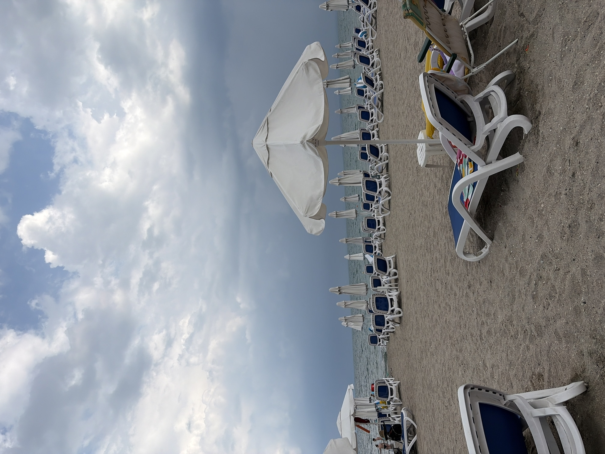 Empty lounge chairs on a cloudy Pomorie beach