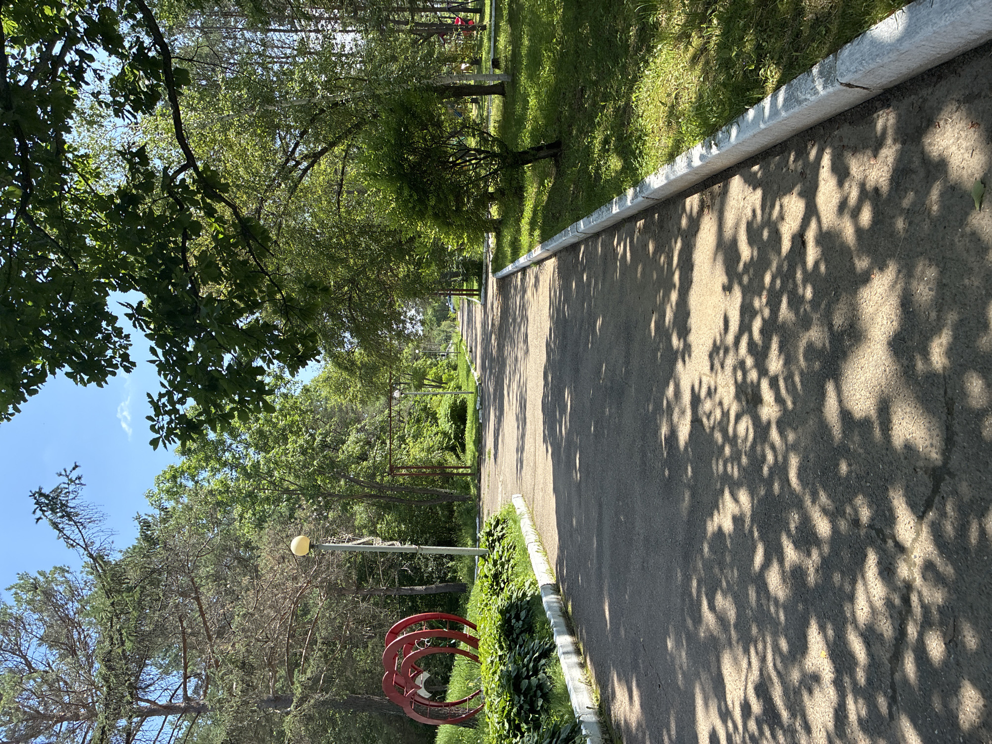 Kids playing at a sunny park playground in Gornye Kljuchi