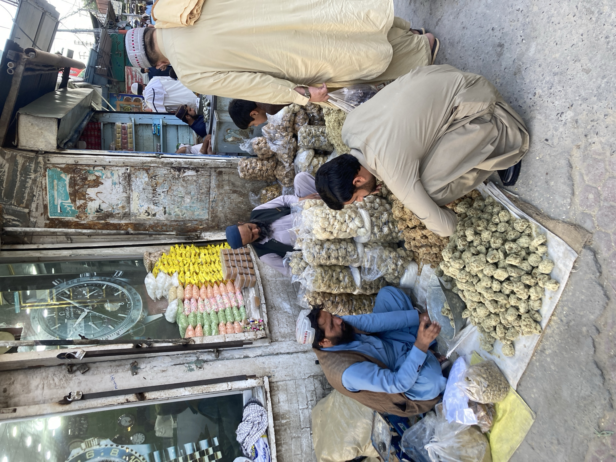Vendor sells dry fruits and candies at Quetta market