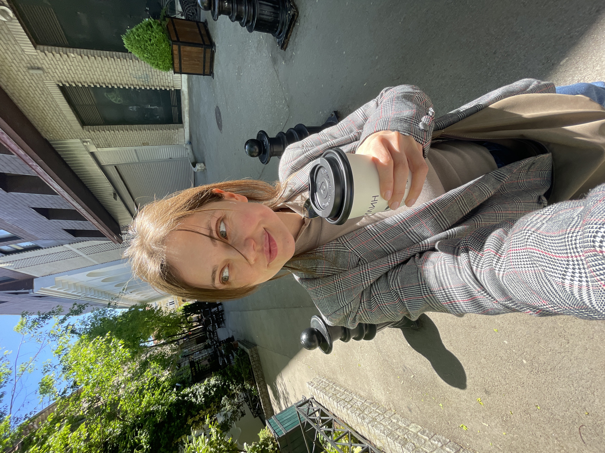 Woman documents sunny coffee walk through historic Subotica streets