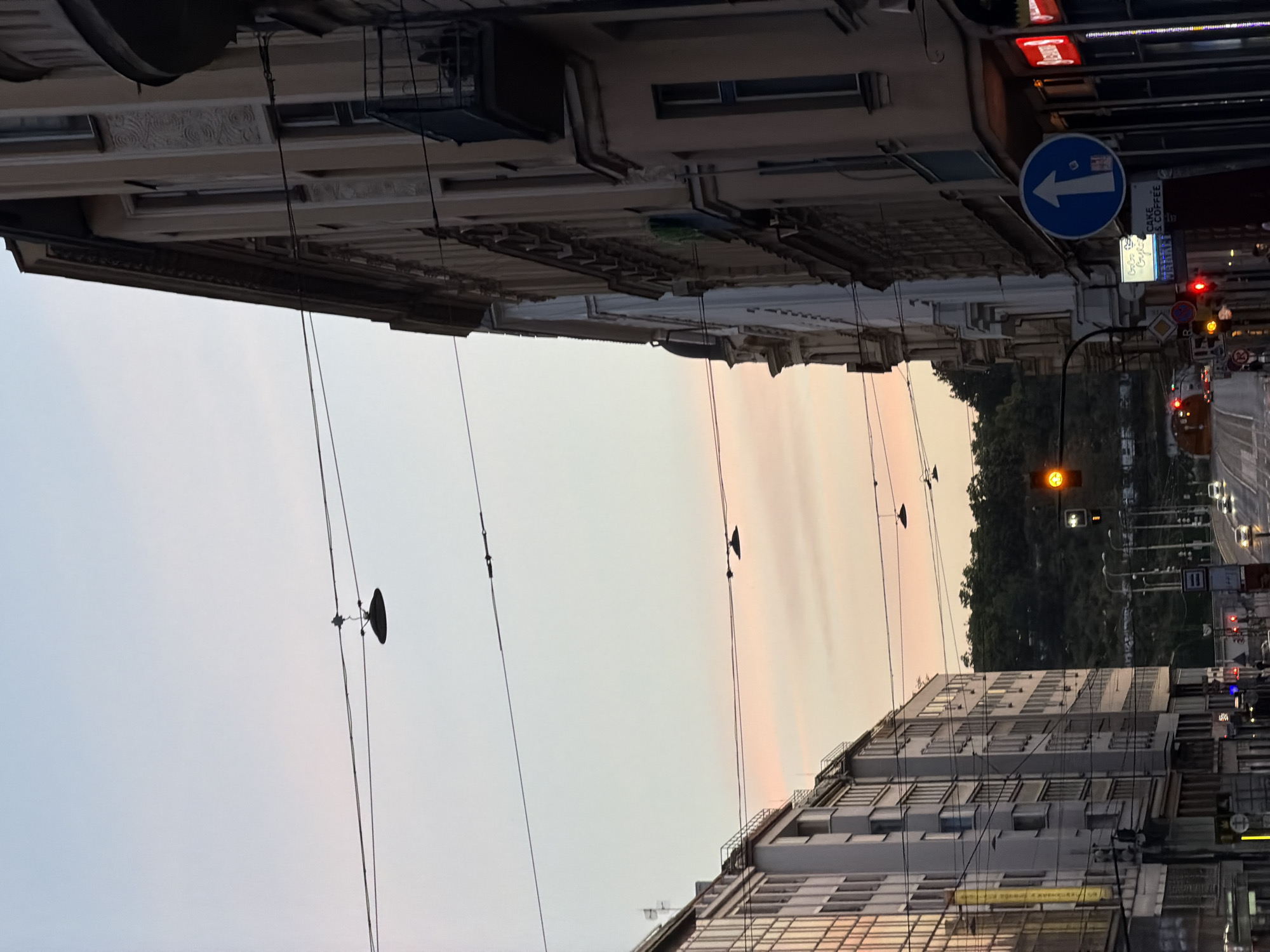 Prague streets at golden hour, moon still hanging in the sky