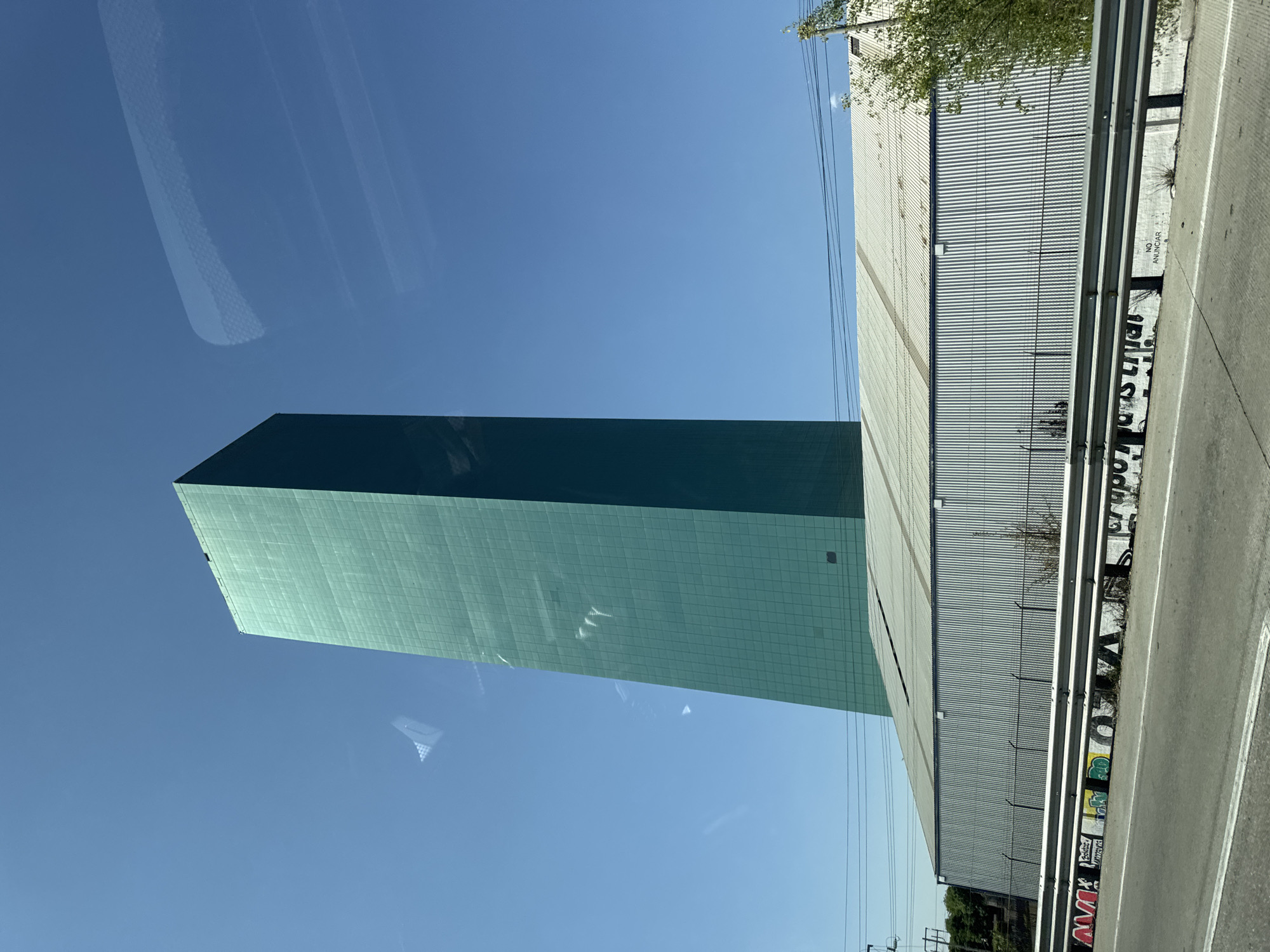 Green gridded building photographed in Santa Ana Xalmimilulco