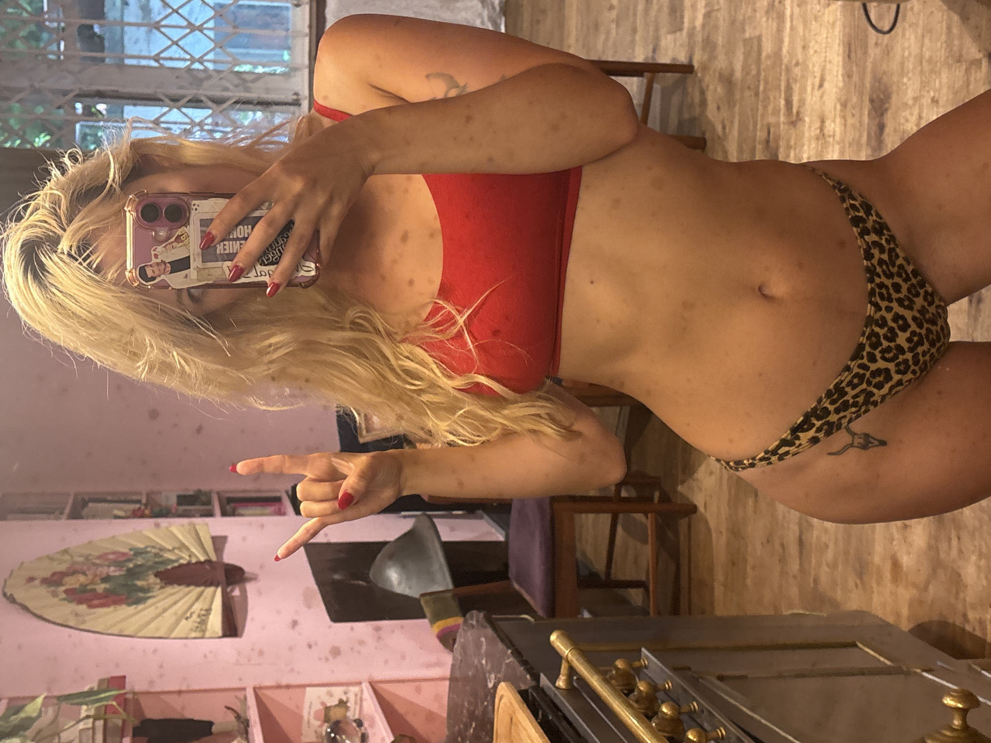 Mirror selfie in London, bold bikini look and rock gesture