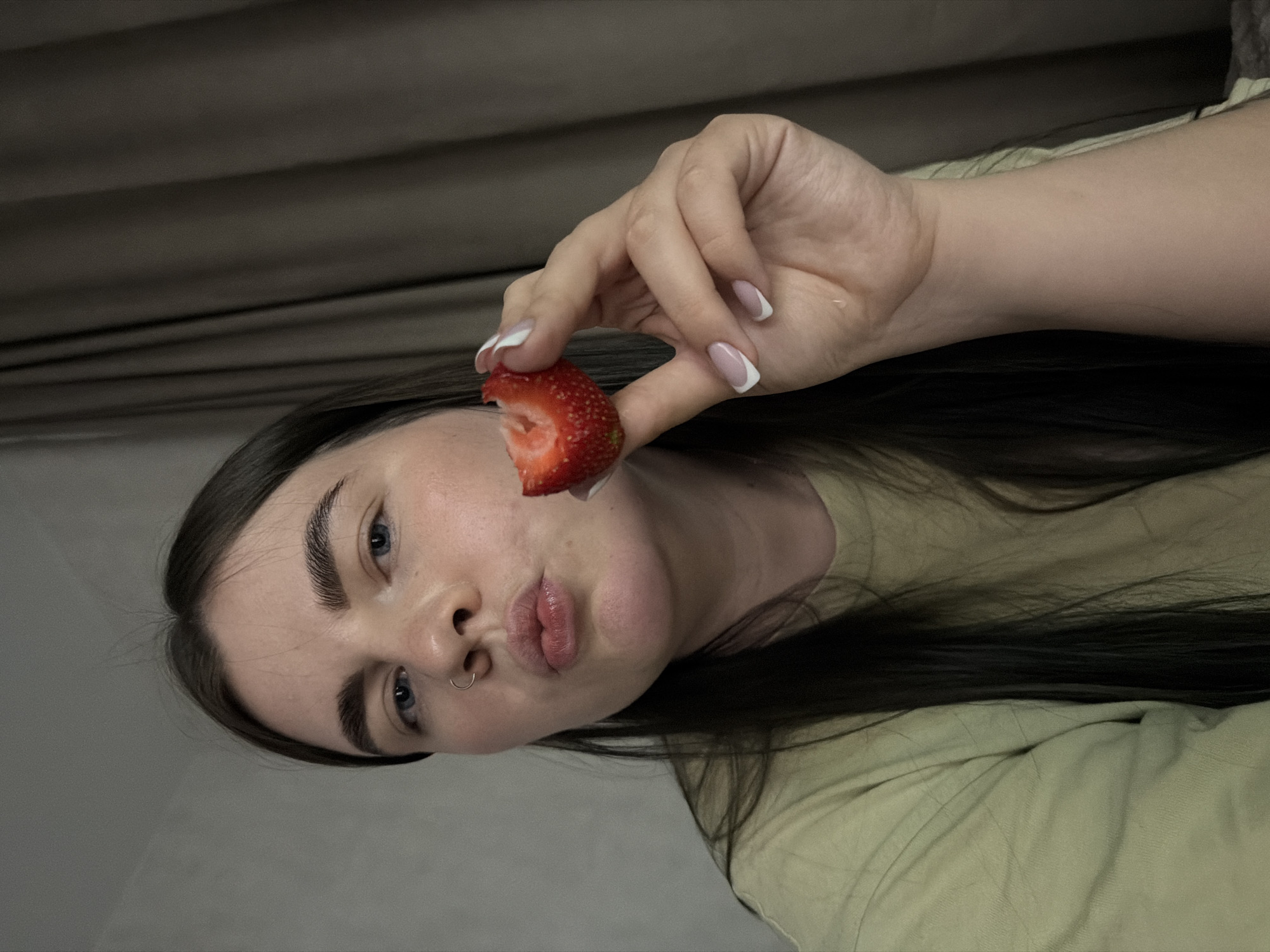 Woman eating strawberry observed in Chaikovsky, Russia
