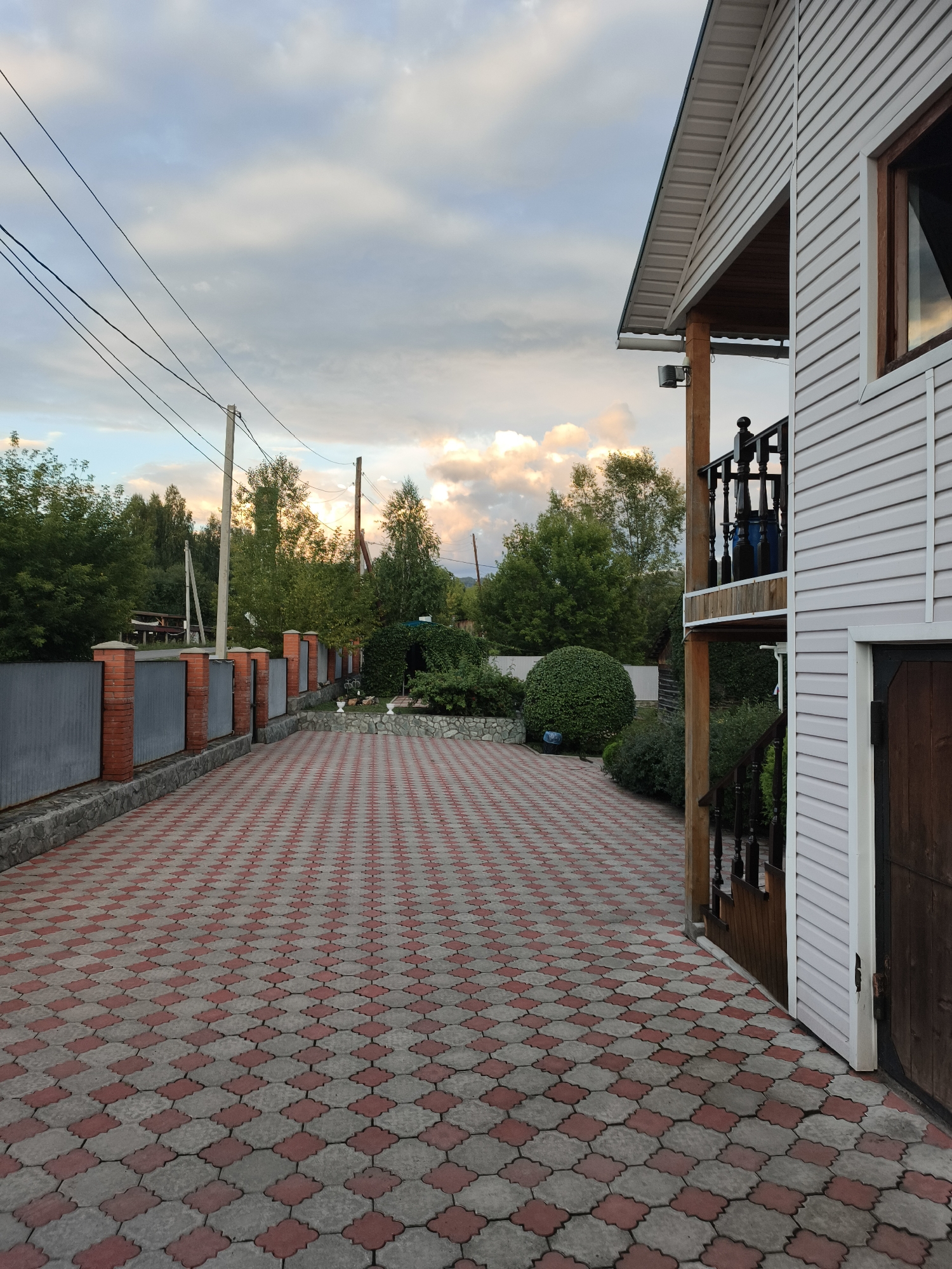 Afternoon at a Katun riverside resort, golden skies and flowering planters